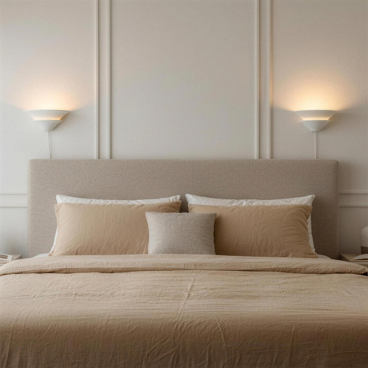Pair of Coppa Serena alabaster wall sconces above a neutral bed