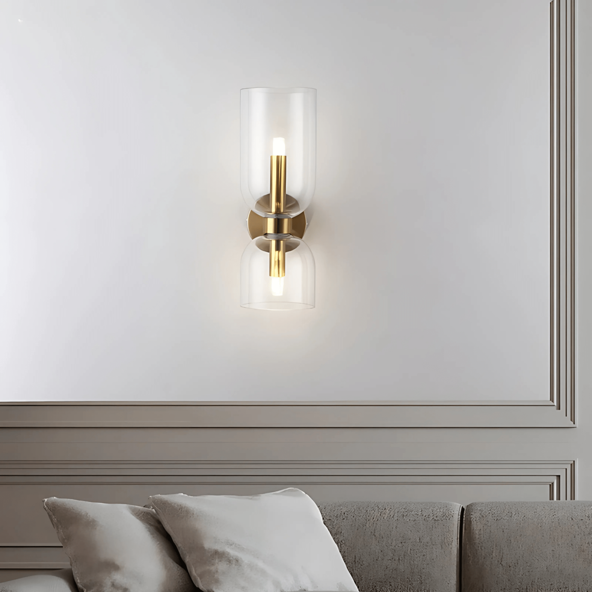 Clear Duetto Glass Wall Sconce above a living-room sofa