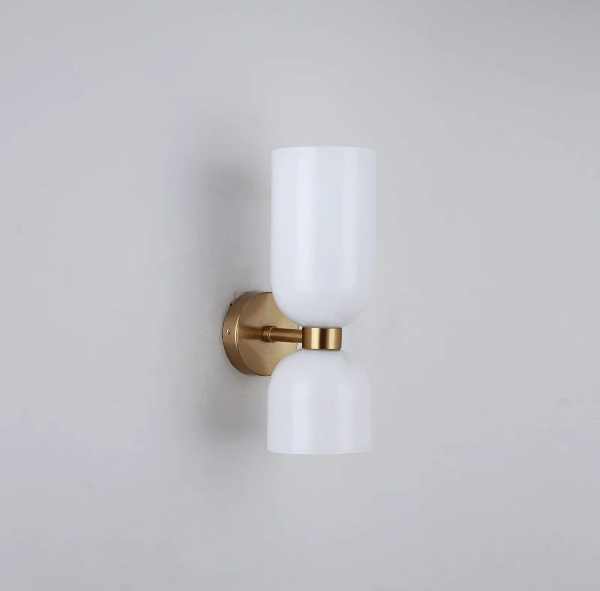 Detail of the Duetto Glass Wall Sconce shade and brass mount