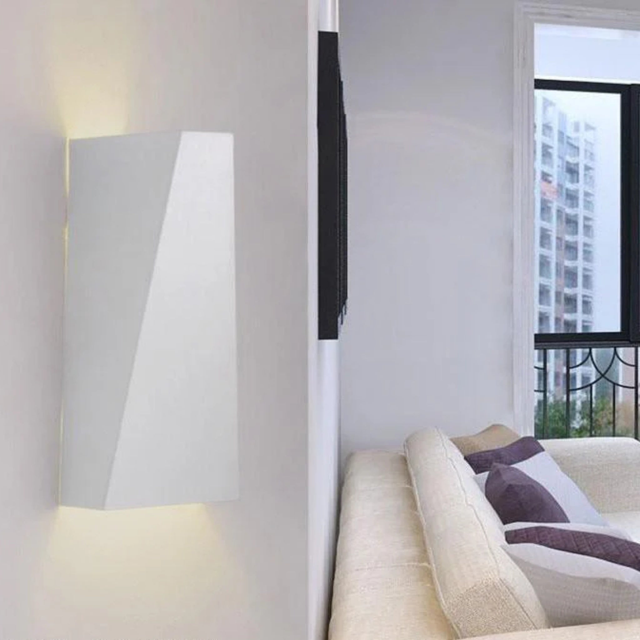 Faccetta Aurora white up down wall sconce styled in a bright living room