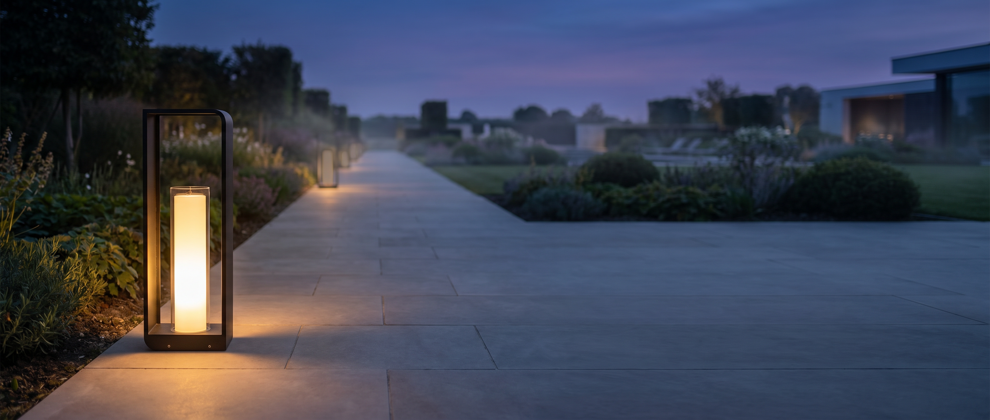 Cornice Lumina outdoor LED landscape light glowing warm white along a garden walkway at dusk