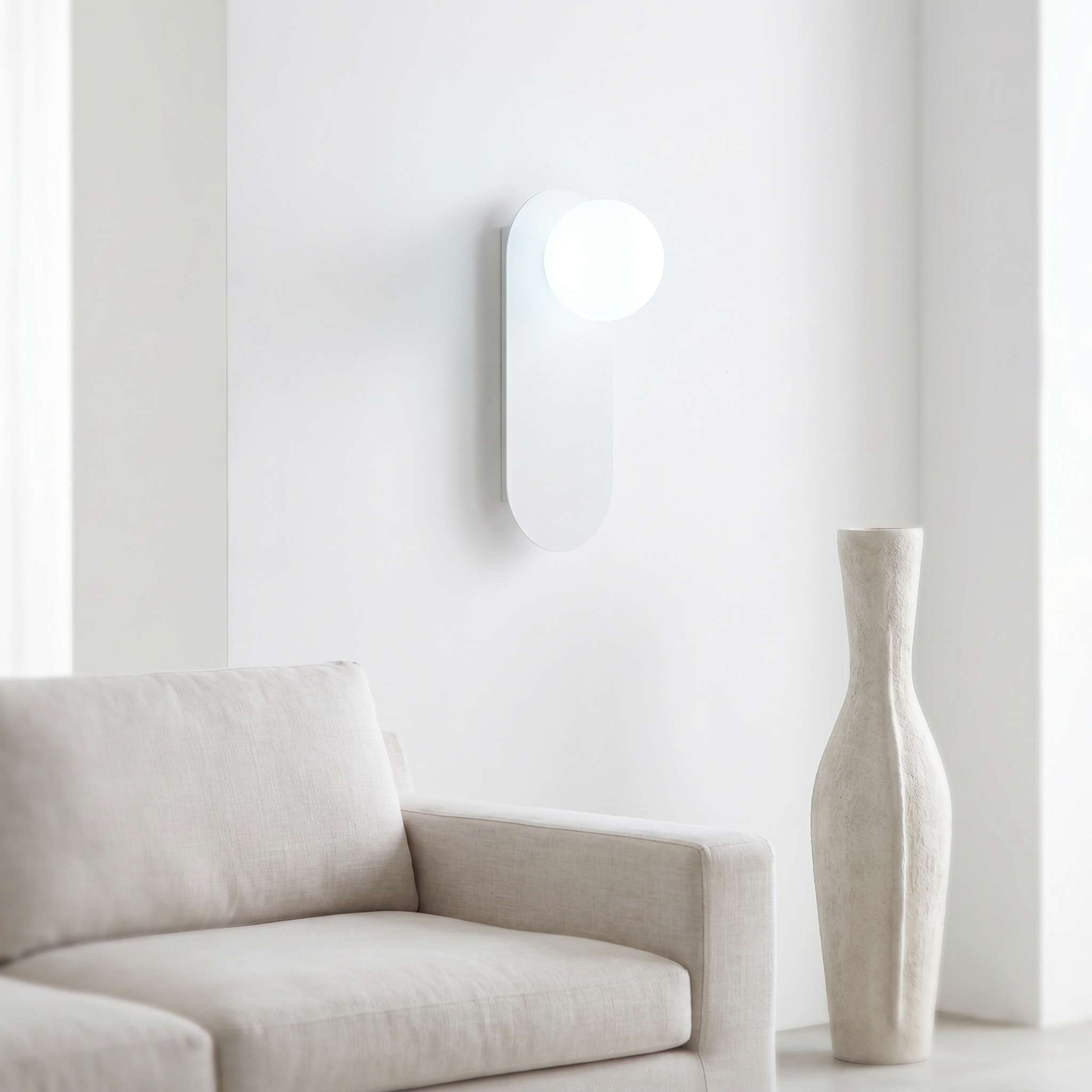 White Sfera Lucente wall sconce with neutral 4000K glow in a bright living room