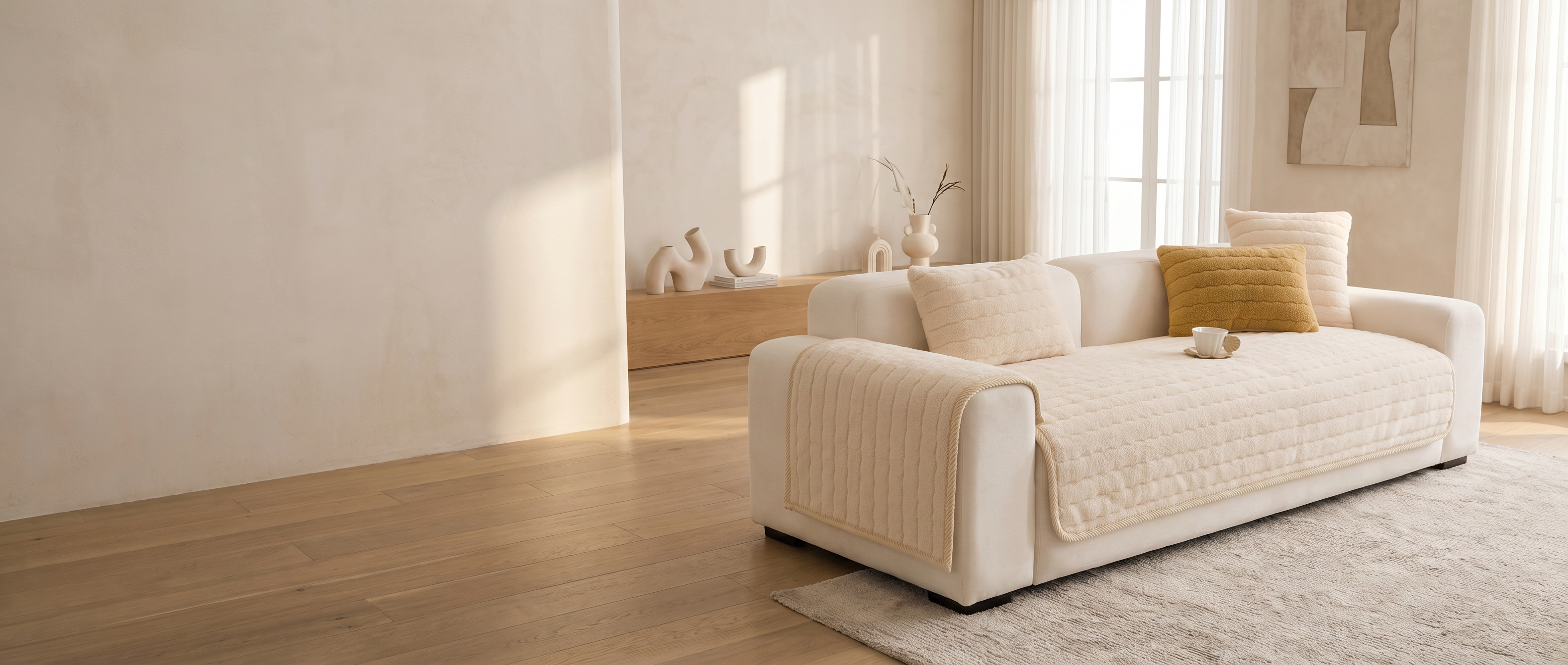 Nuvola cream plush channel-quilted sofa cover in a sunlit modern living room — widescreen banner