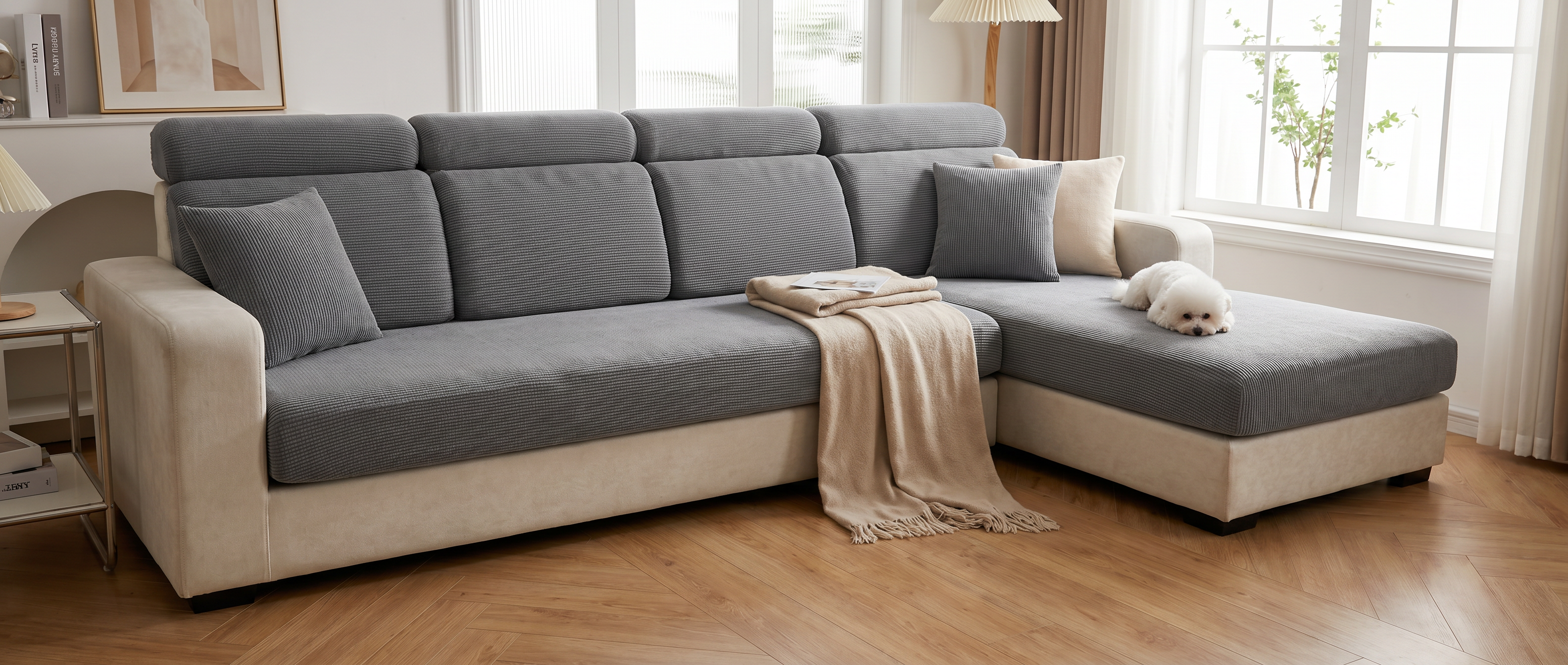 Grey stretch jacquard cushion covers on a sectional sofa in a bright living room with a small dog