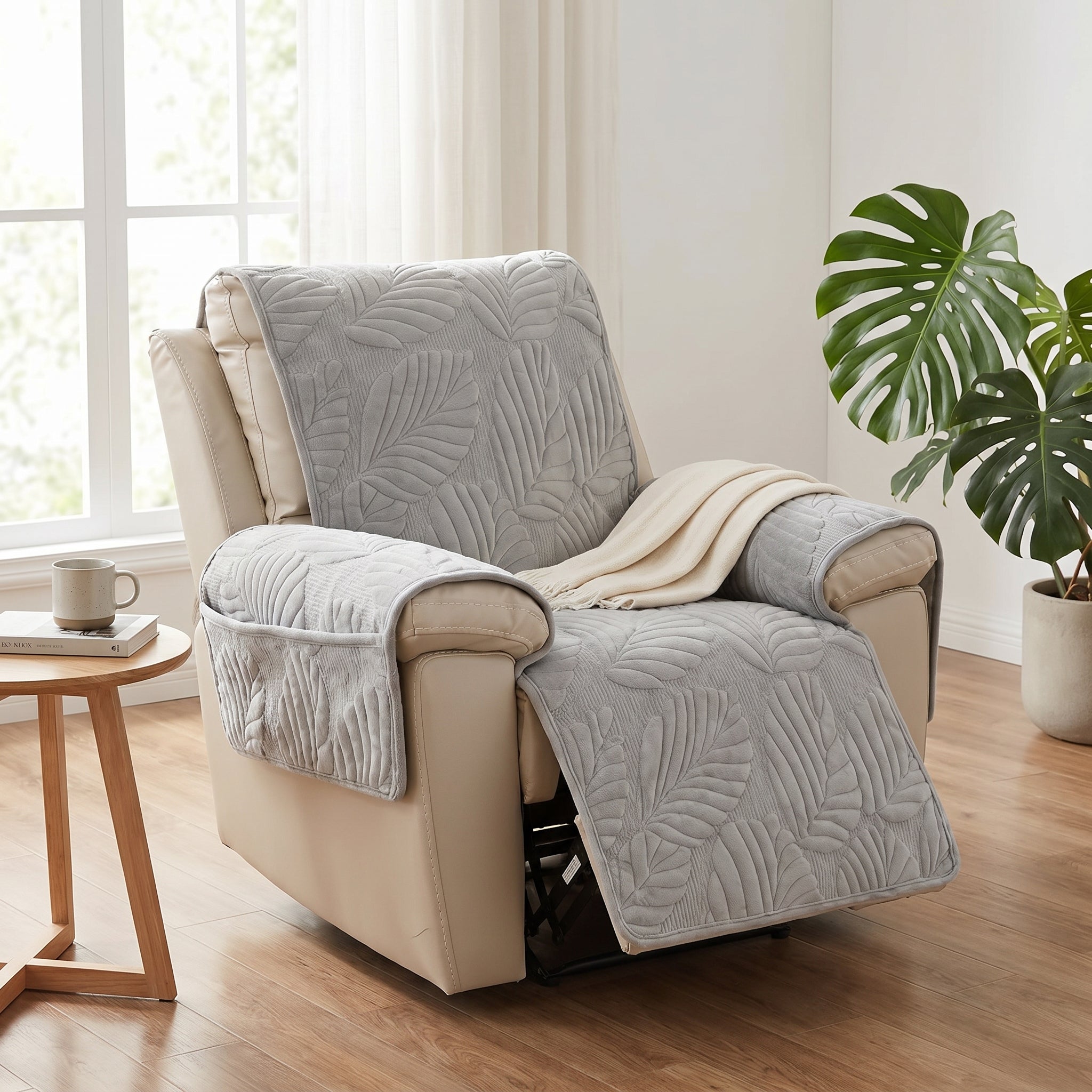 Light grey quilted leaf-pattern recliner slipcover fitted on a recliner in a calm modern living room