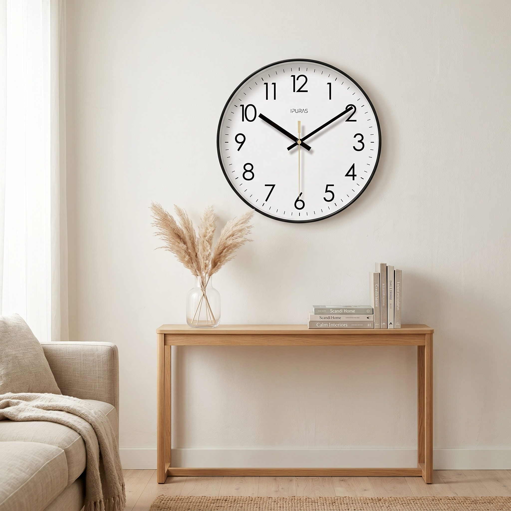Black Nordic wall clock above an oak console in a calm living room