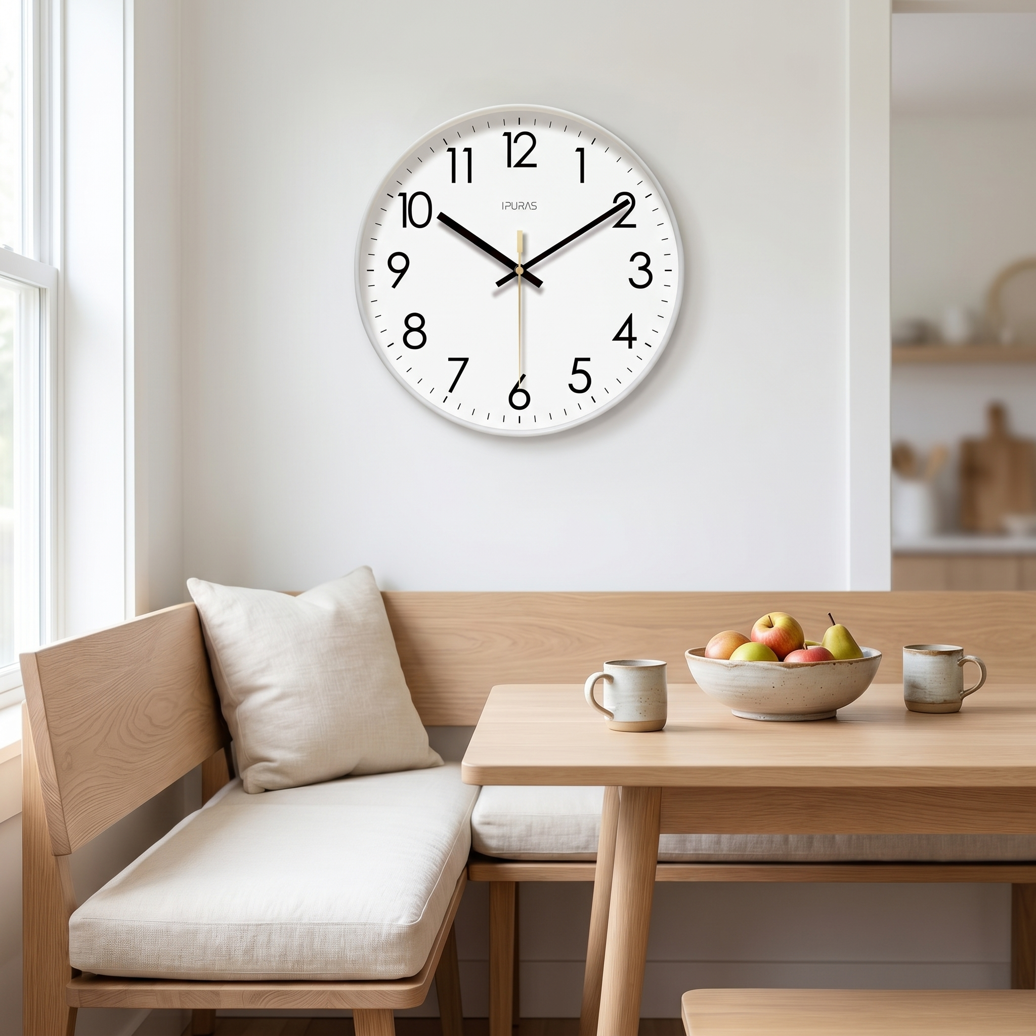 White Nordic wall clock above a wooden dining nook in a bright kitchen