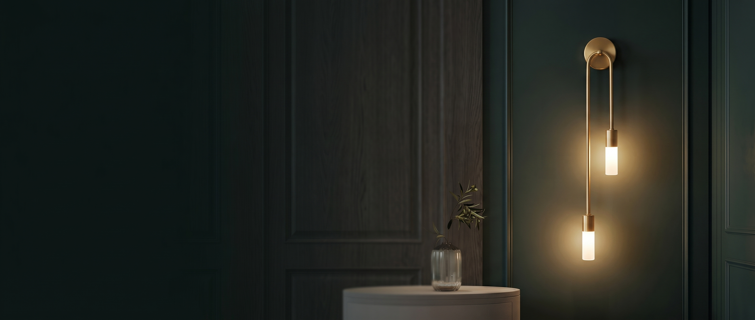 Carezza Luminosa wall sconce banner — warm-lit gold fixture on a dark elegant wall