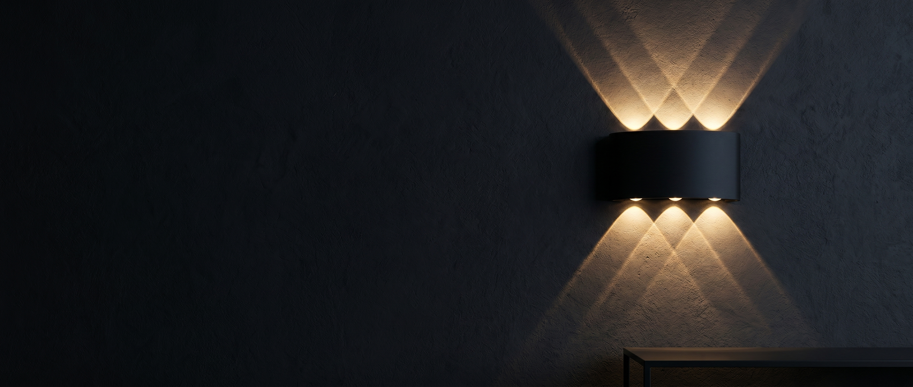 Aura Soffusa up-down LED wall light banner — warm beams on a dark wall