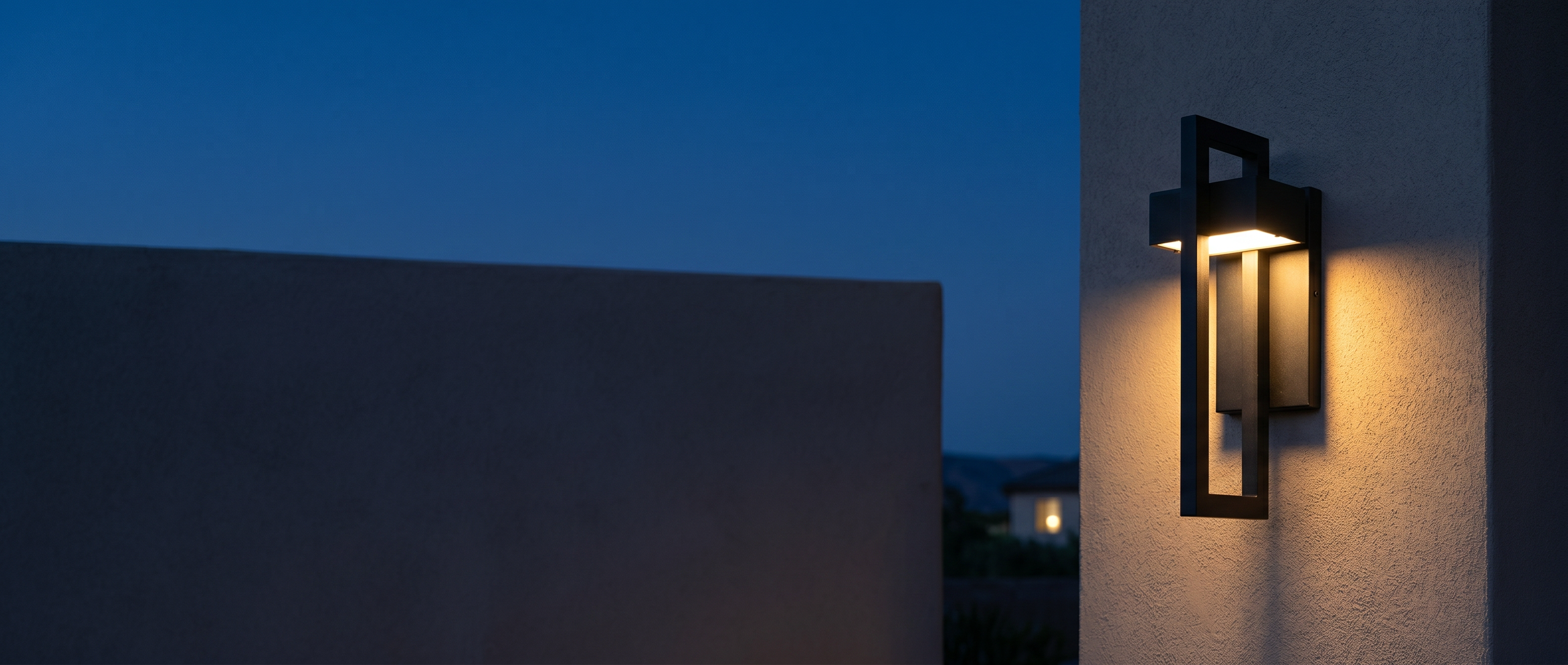 Cornice outdoor wall light banner — warm up-and-down glow at dusk