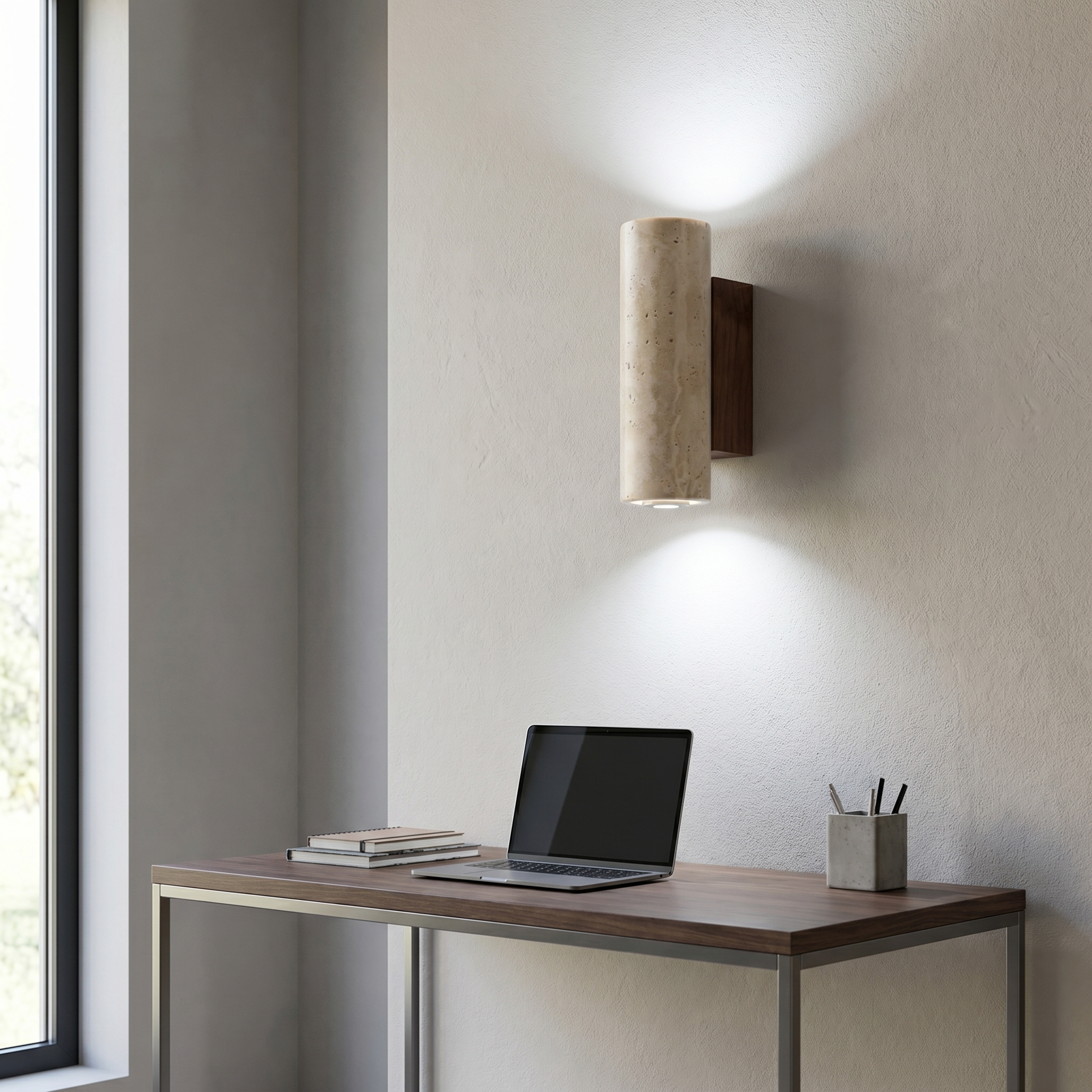 Travertine wall sconce with cool white glow above a minimalist home office desk