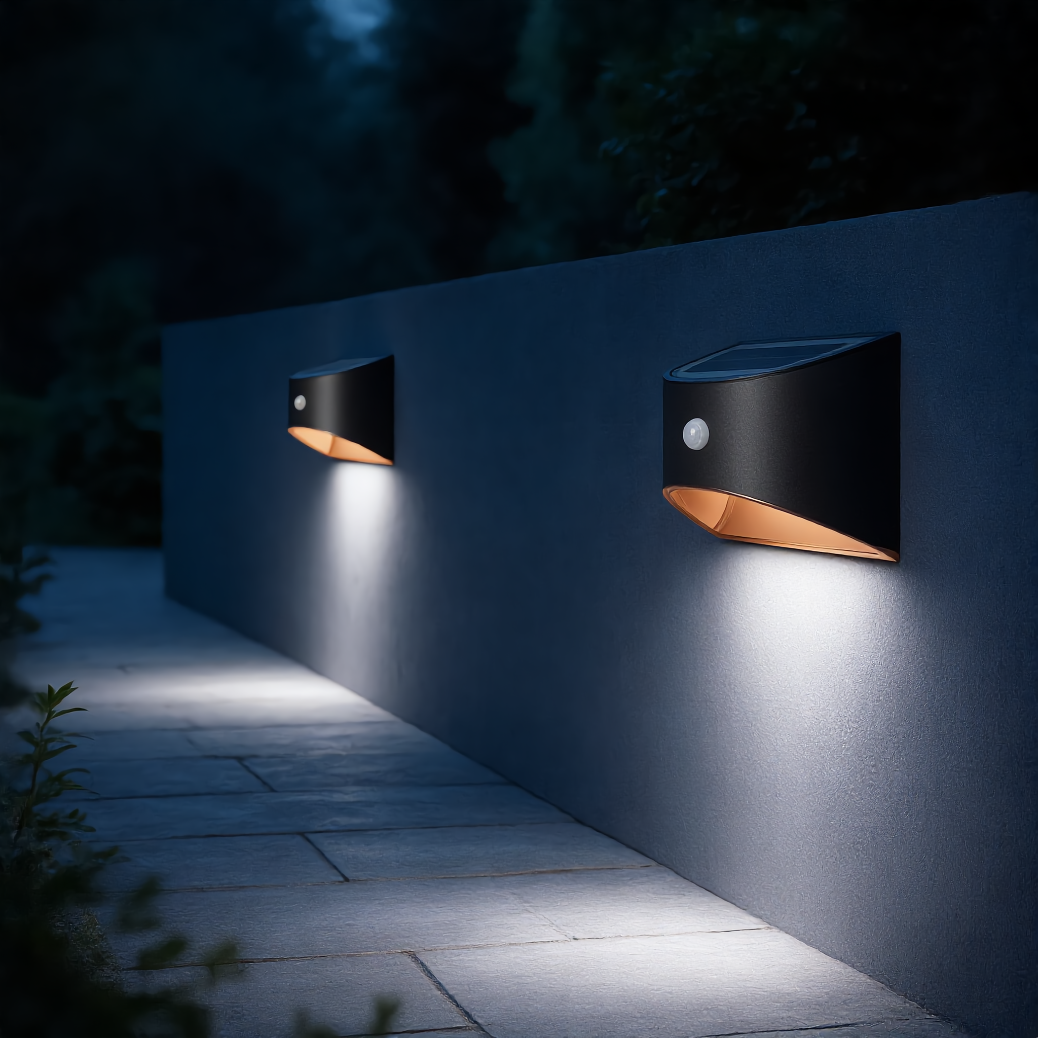 Two black Stella Solare solar wall lights along a garden pathway with cool white glow