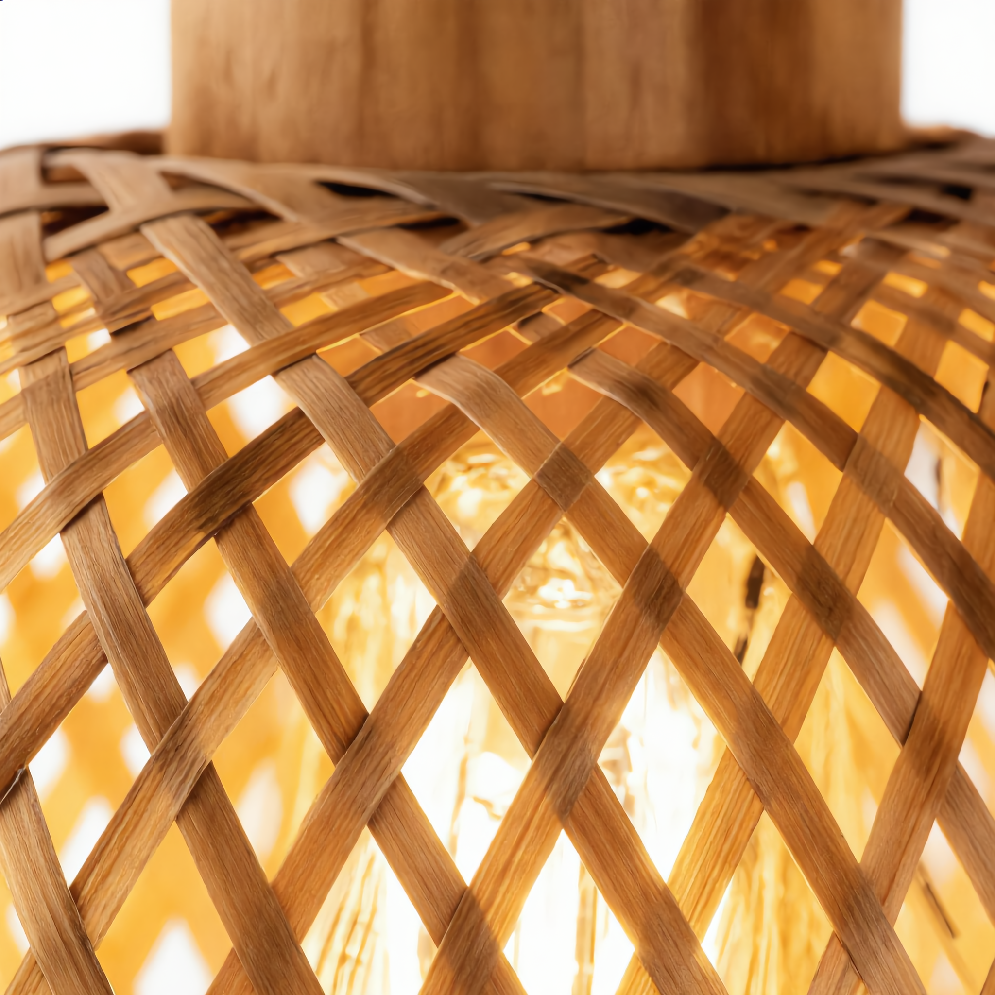 Close-up of the Intreccio rattan weave glowing warm around the bulb
