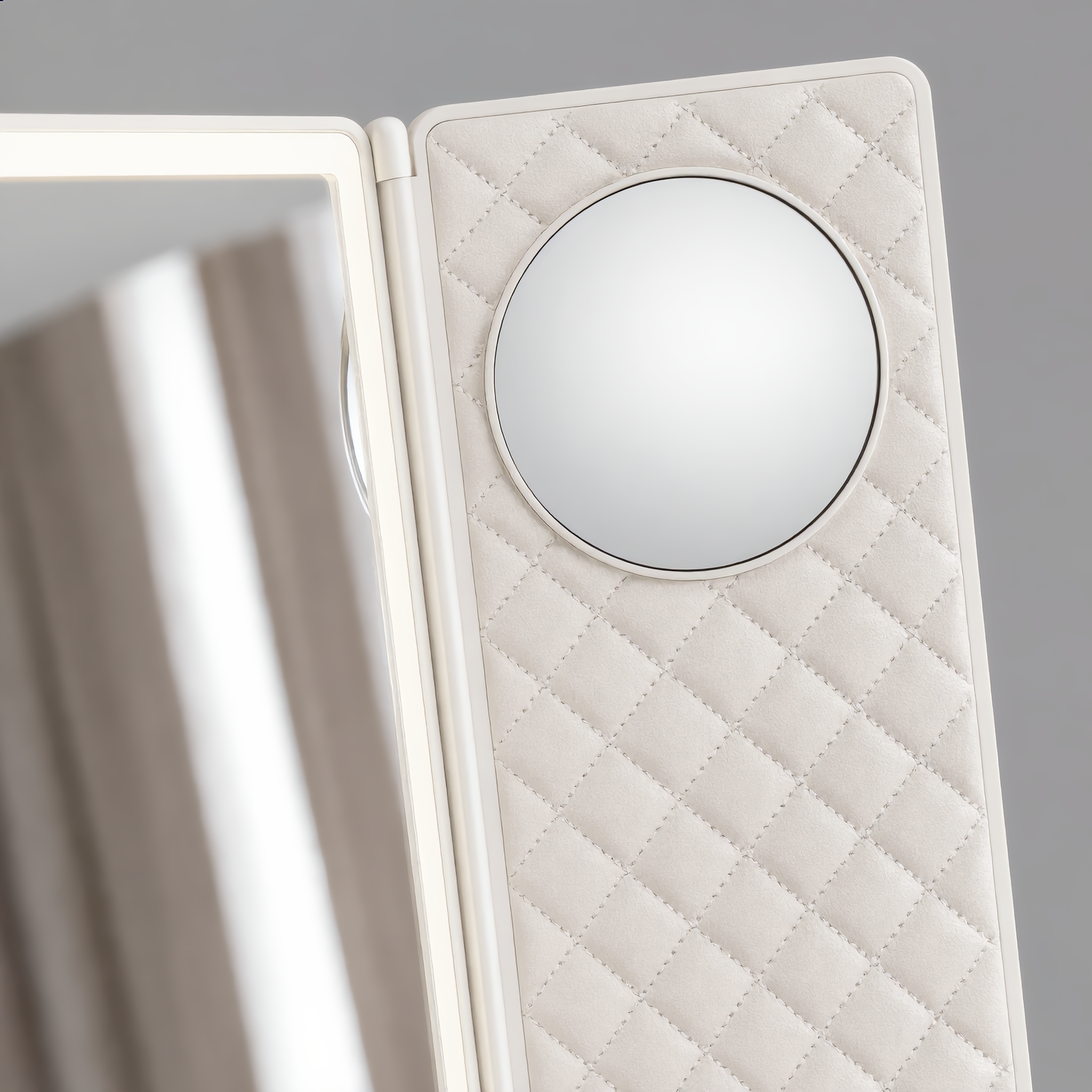 Close-up of the side panels with round magnifier on the trifold mirror