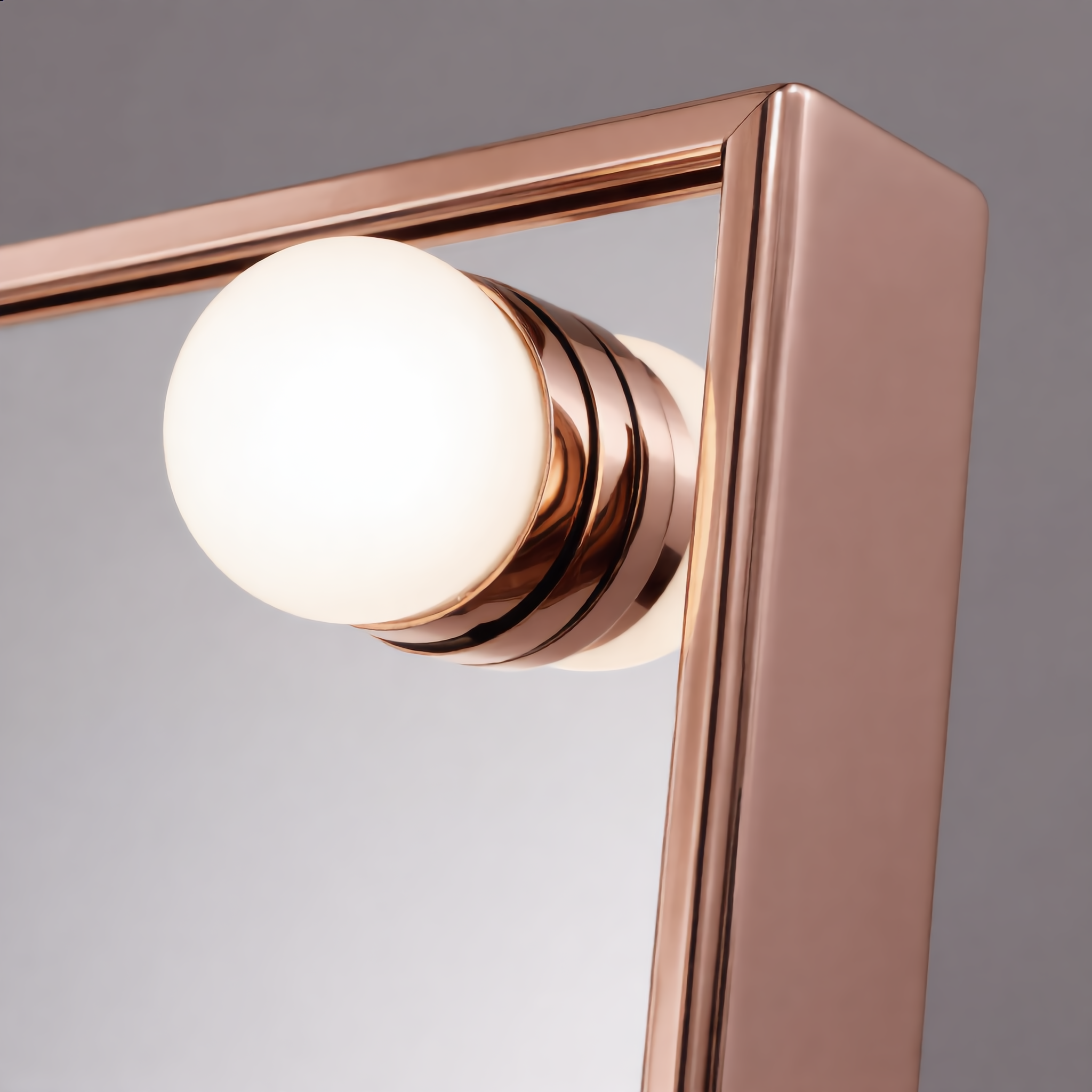 Close-up of a frosted LED bulb on the rose gold mirror frame