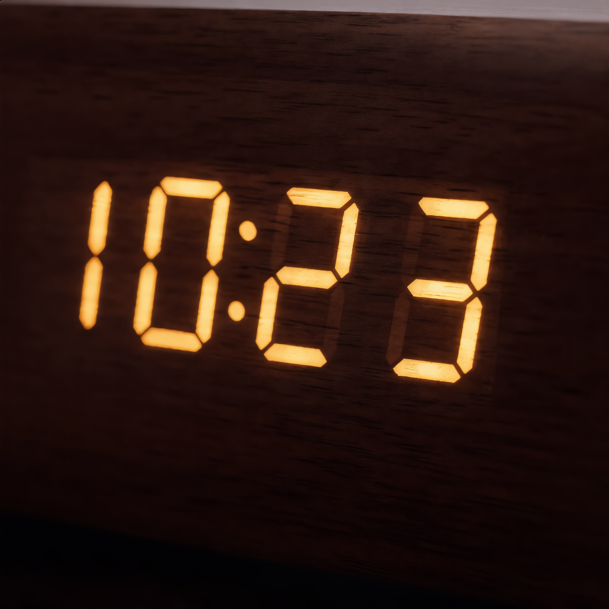 Close-up of the LED display glowing through the wood grain