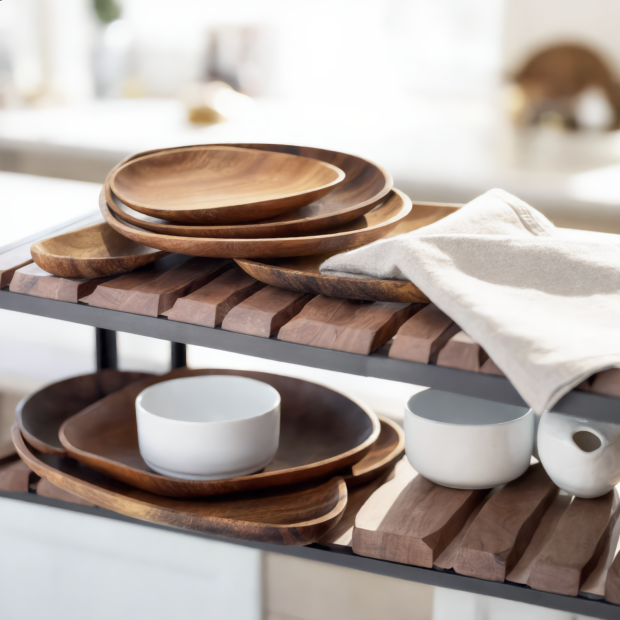 Nested set of acacia trays on a bright kitchen shelf