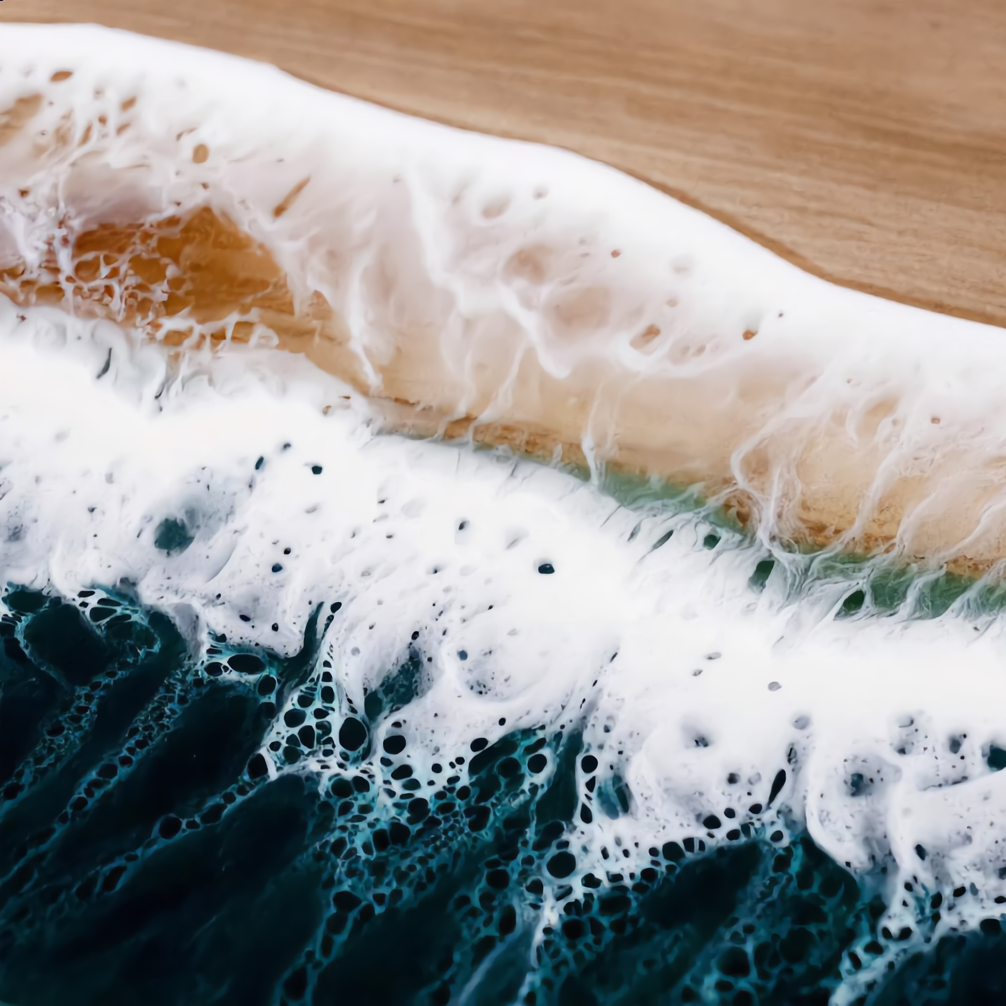 Macro of the sandy shoreline resin blending into acacia woodgrain