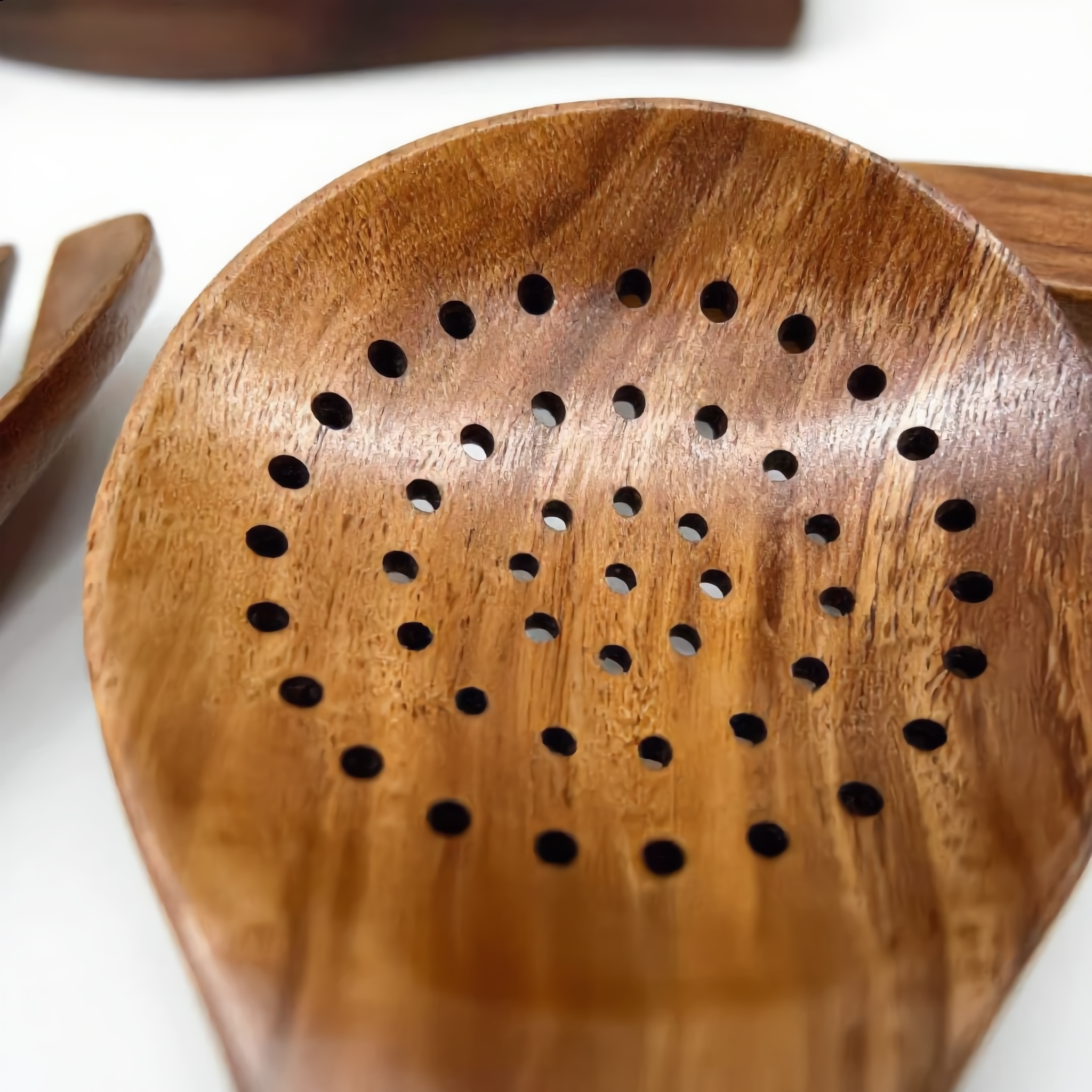 Close-up of the teak slotted skimmer drainage holes