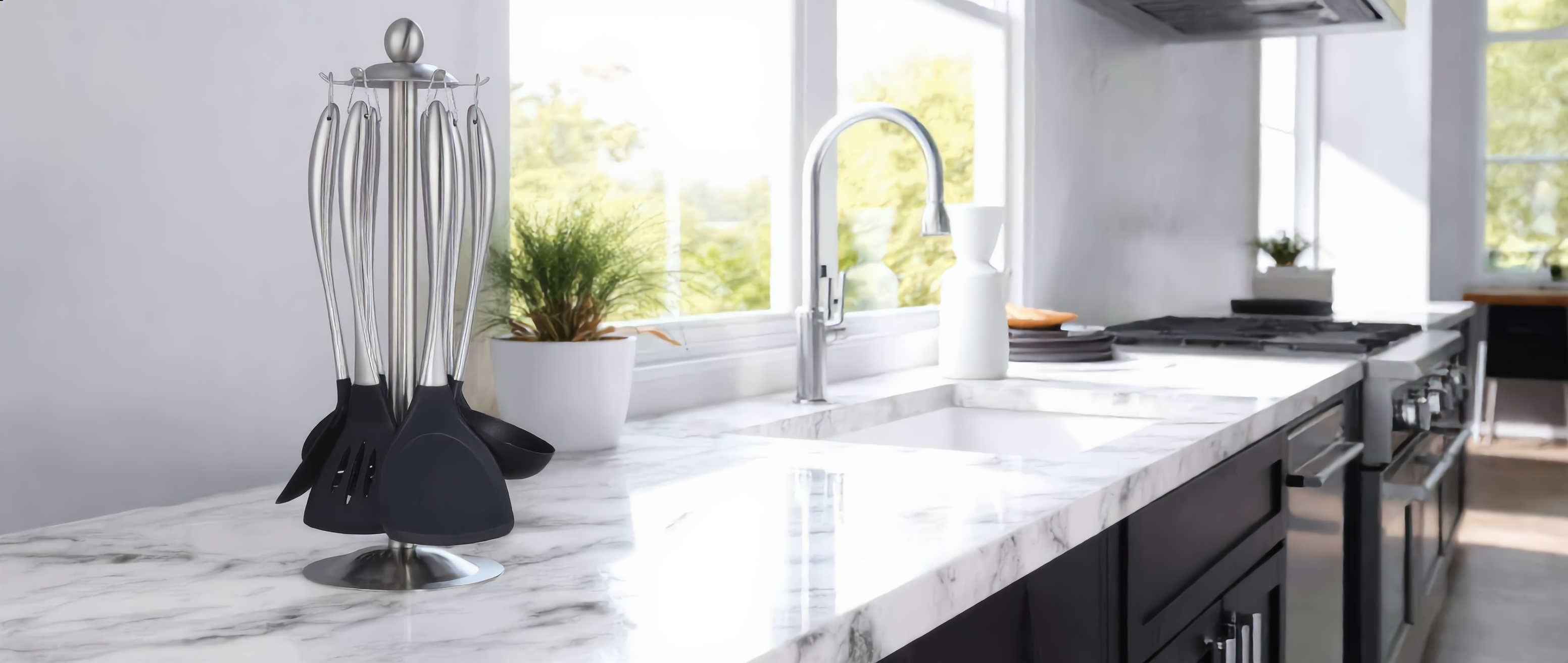 Lustro Non-Stick Utensil Set on its rotating carousel stand in a bright modern kitchen