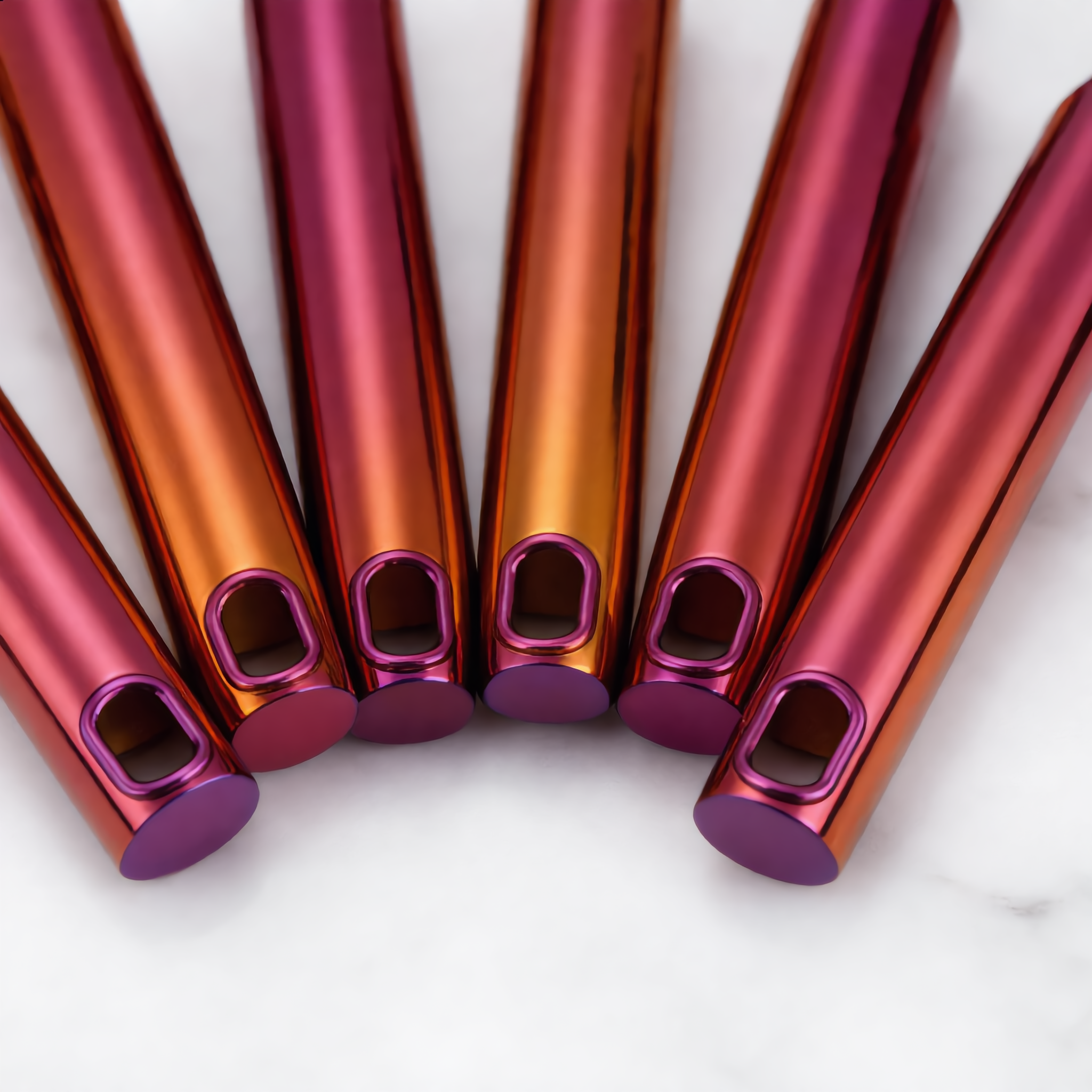 Macro of the slim hollow handle ends with hanging holes and iridescent finish