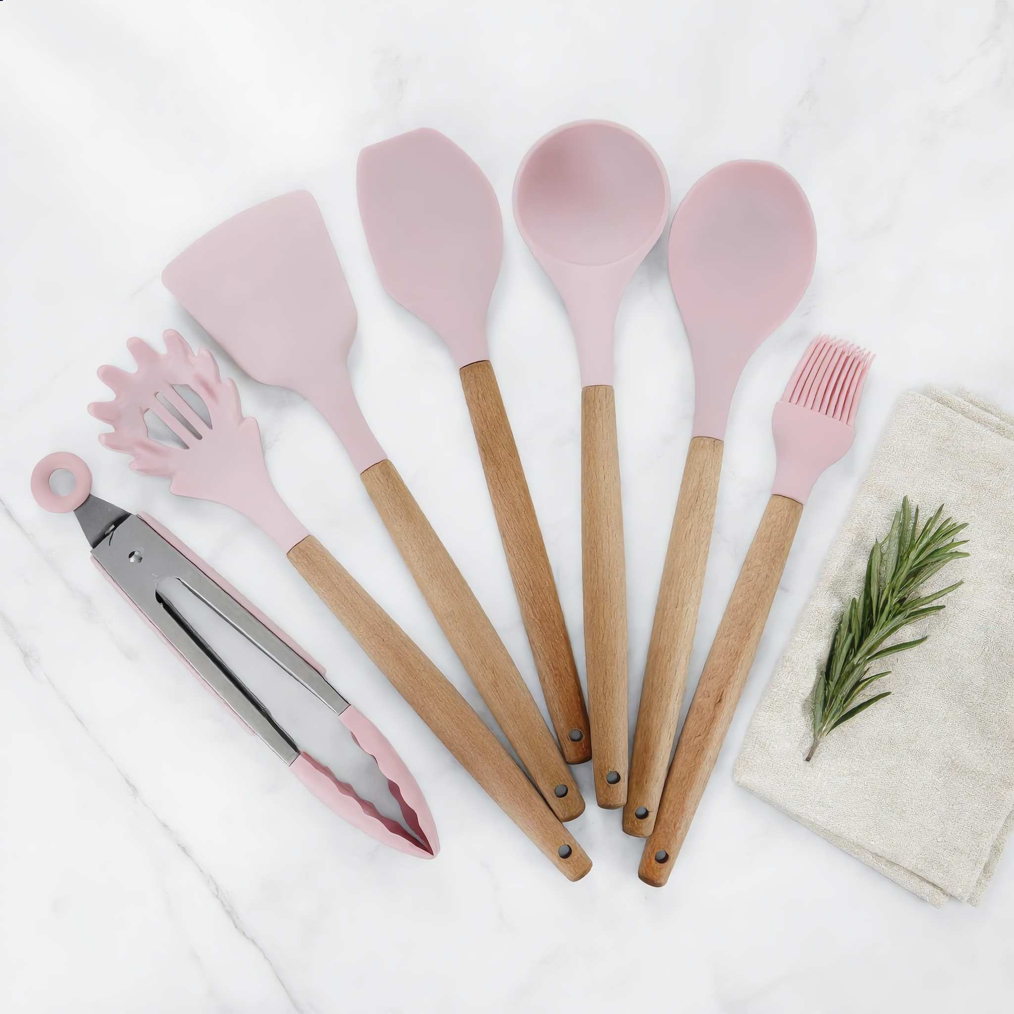 Rose Morbido utensils flat-lay on marble with linen and rosemary