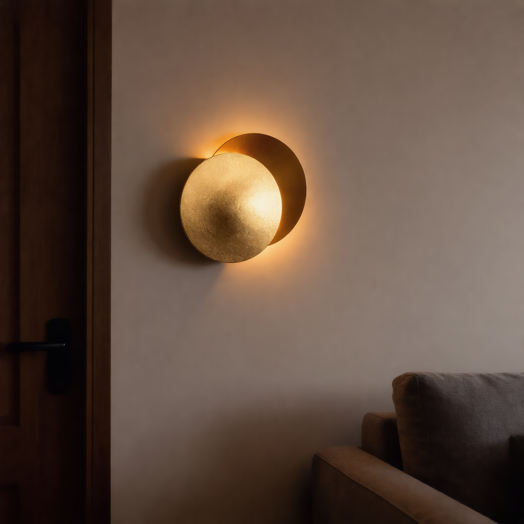 Eclissi wall sconce above a grey sofa in a living room