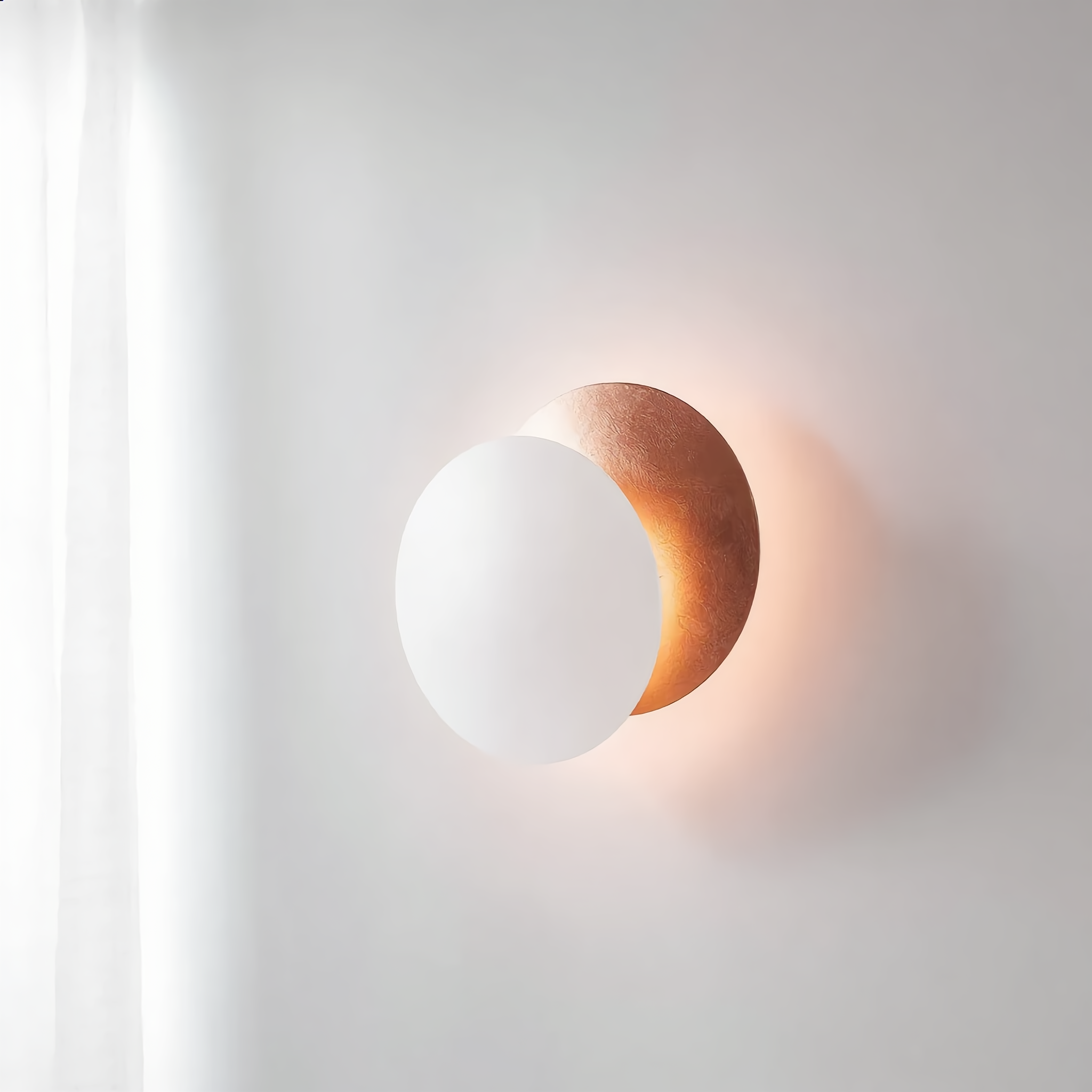 Eclissi White and Rose Gold wall sconce in a minimalist bedroom