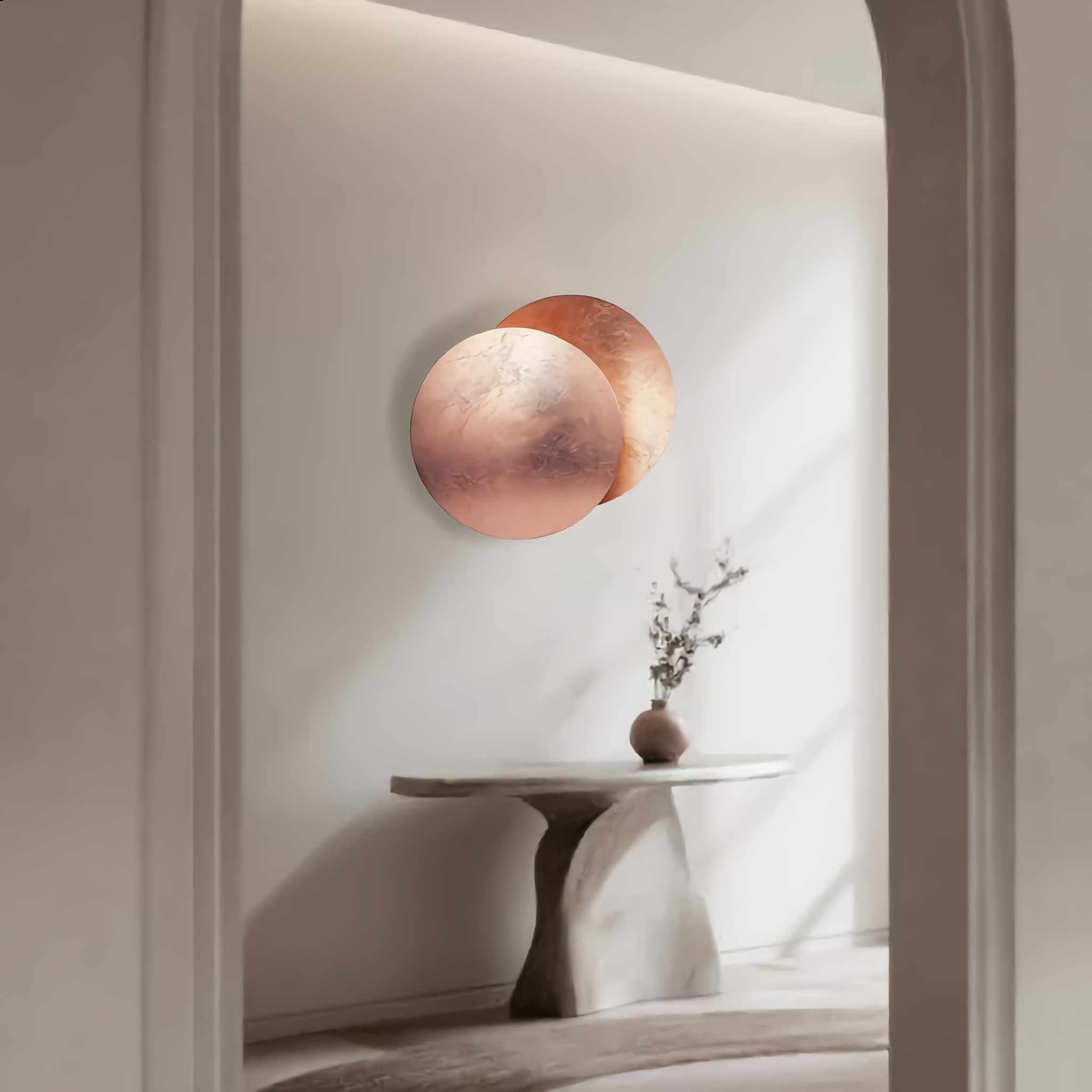 Eclissi Rose Gold wall sconce above a bright entryway console table