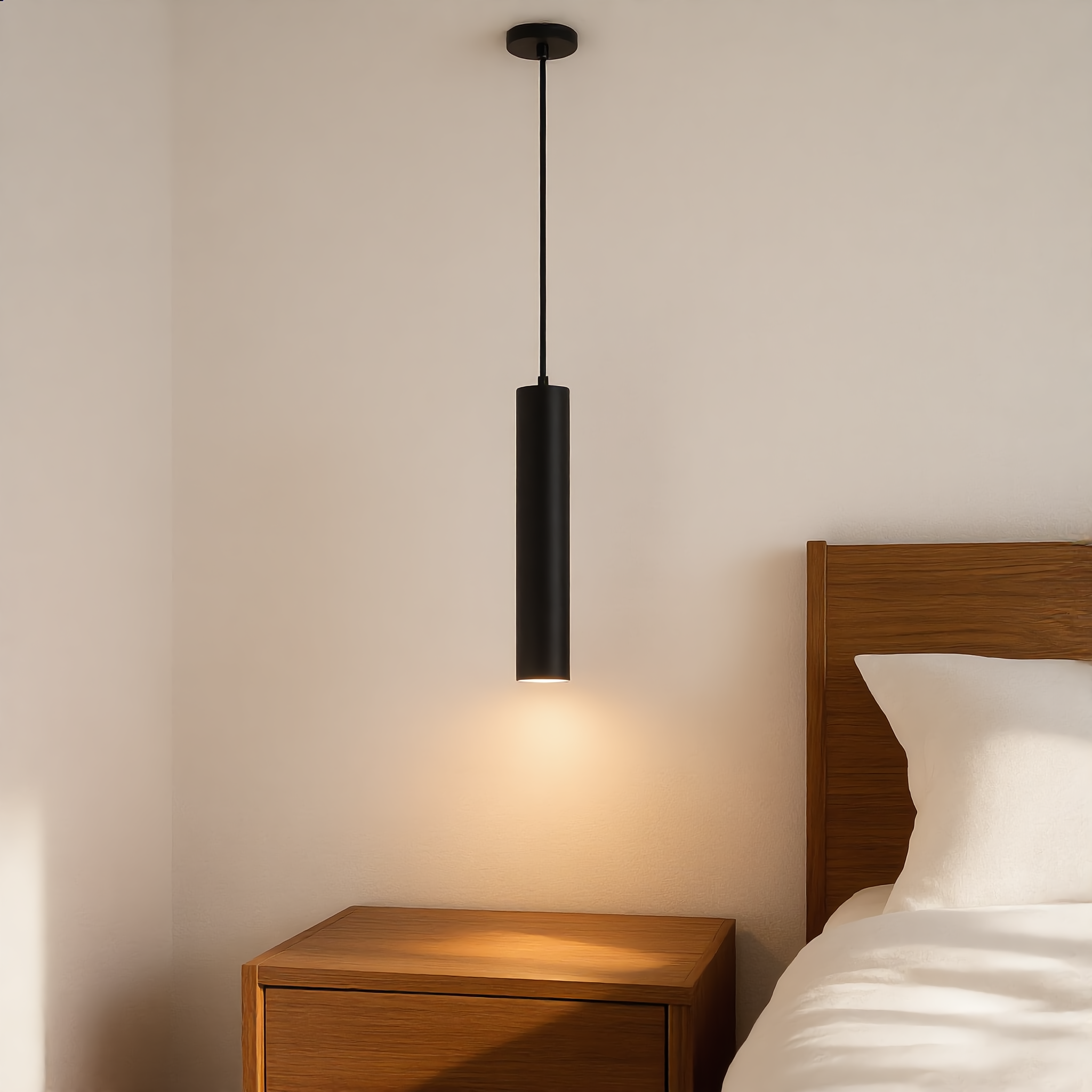 Cometa black tube pendant beside a nightstand