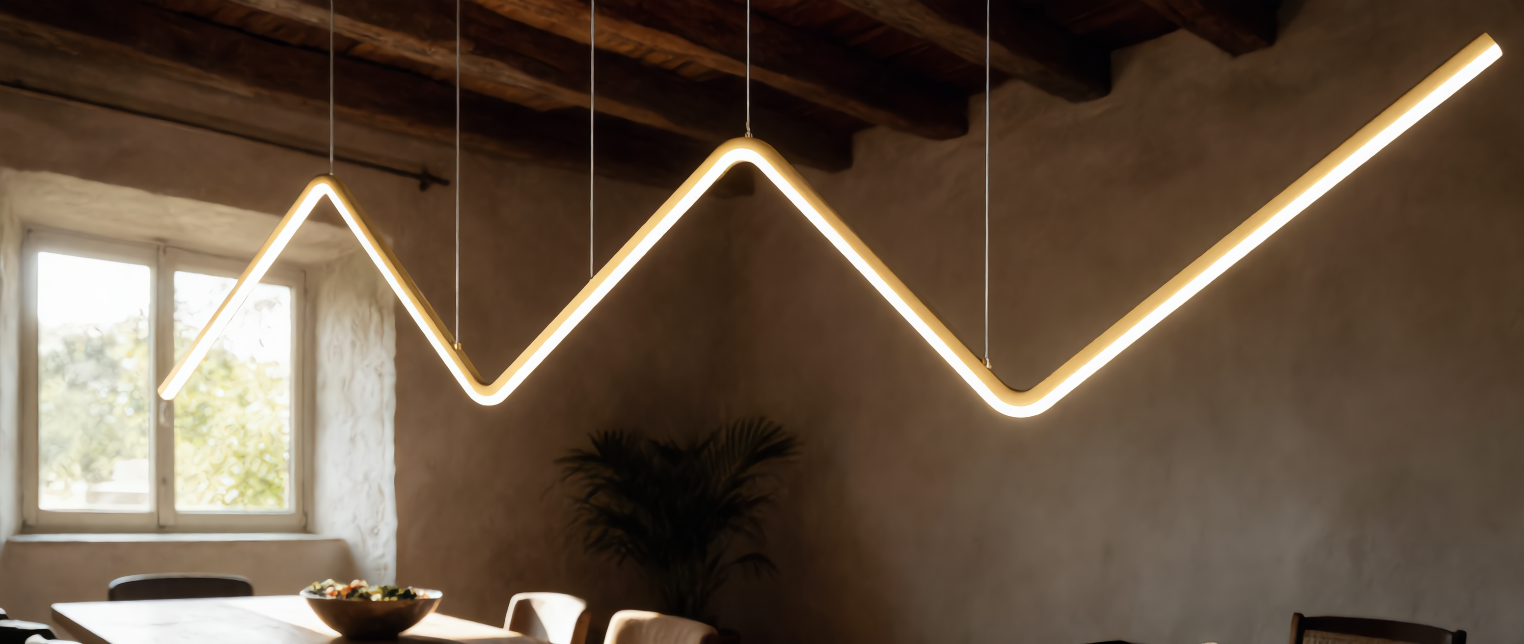 Lampo gold zigzag linear LED pendant in a luxurious sunlit dining room
