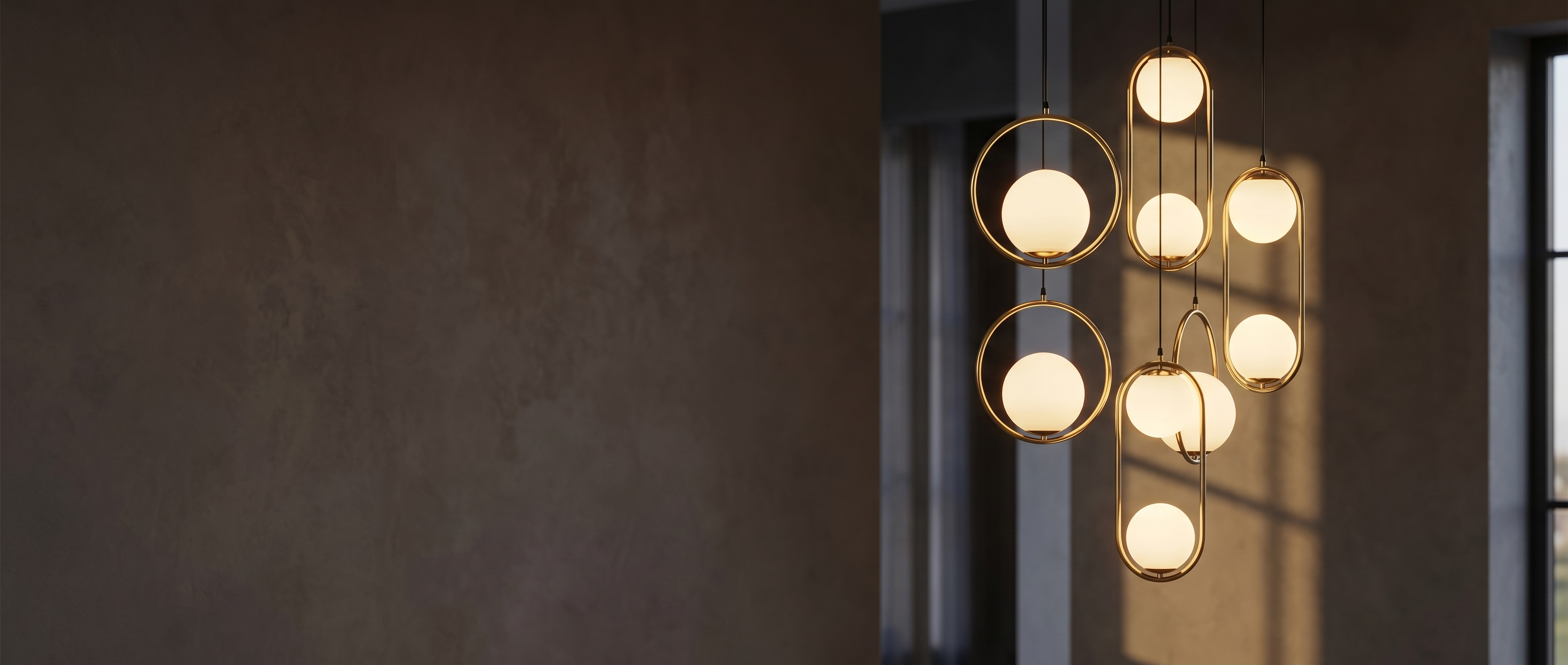 A cluster of brass Sfera glass-globe pendants glowing warmly
