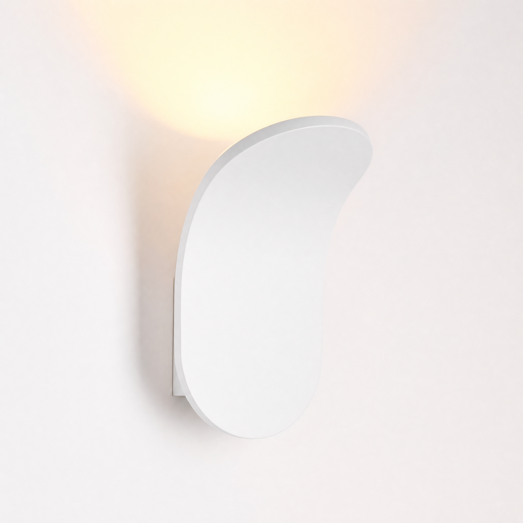Matte white curved wall sconce warm white glow