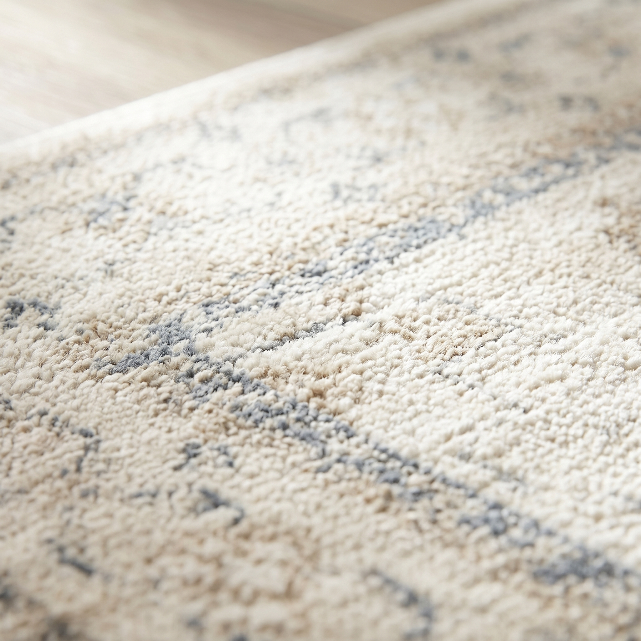 Macro detail of the rug pile showing soft wool texture and faded pattern
