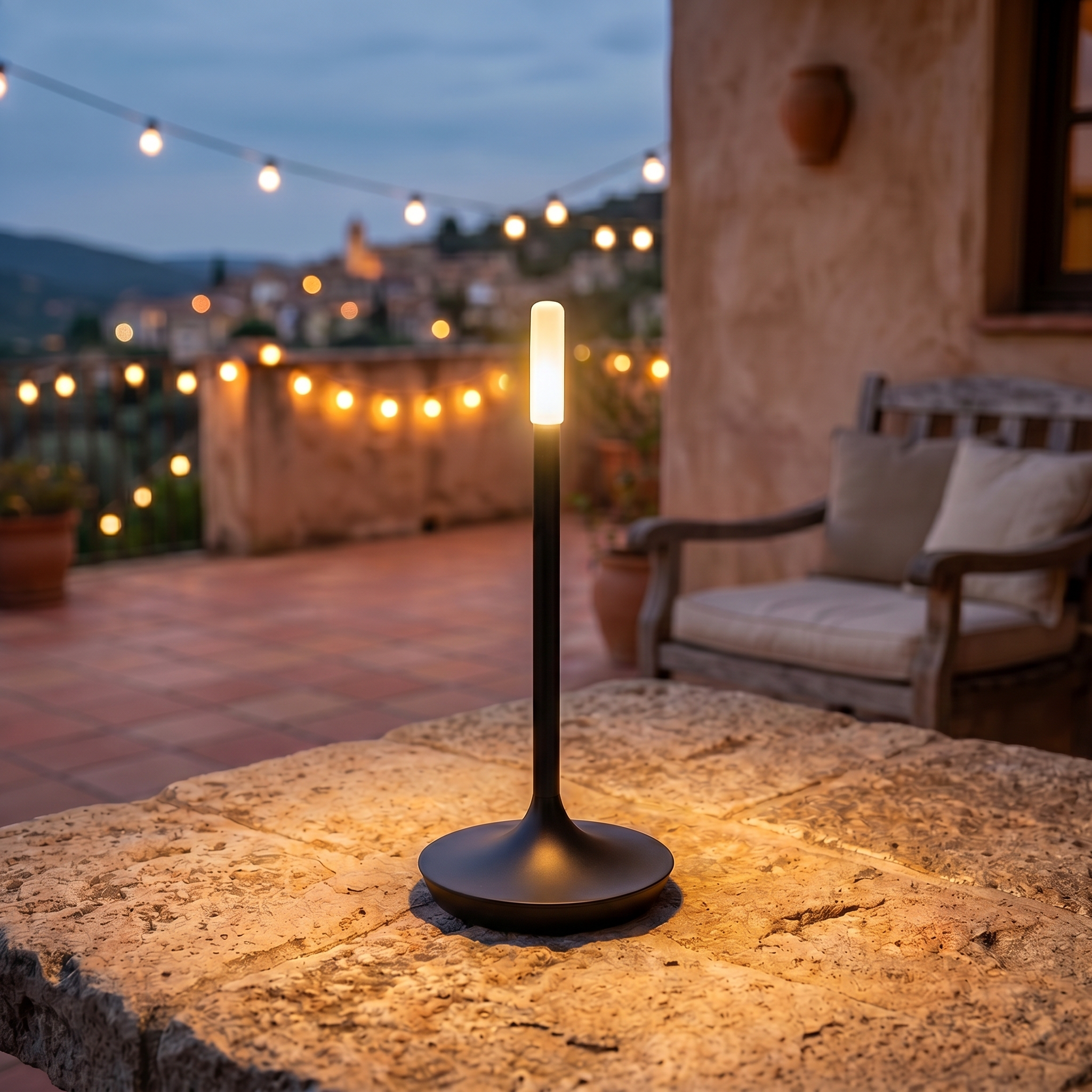Fiamma black lamp on a patio table at dusk