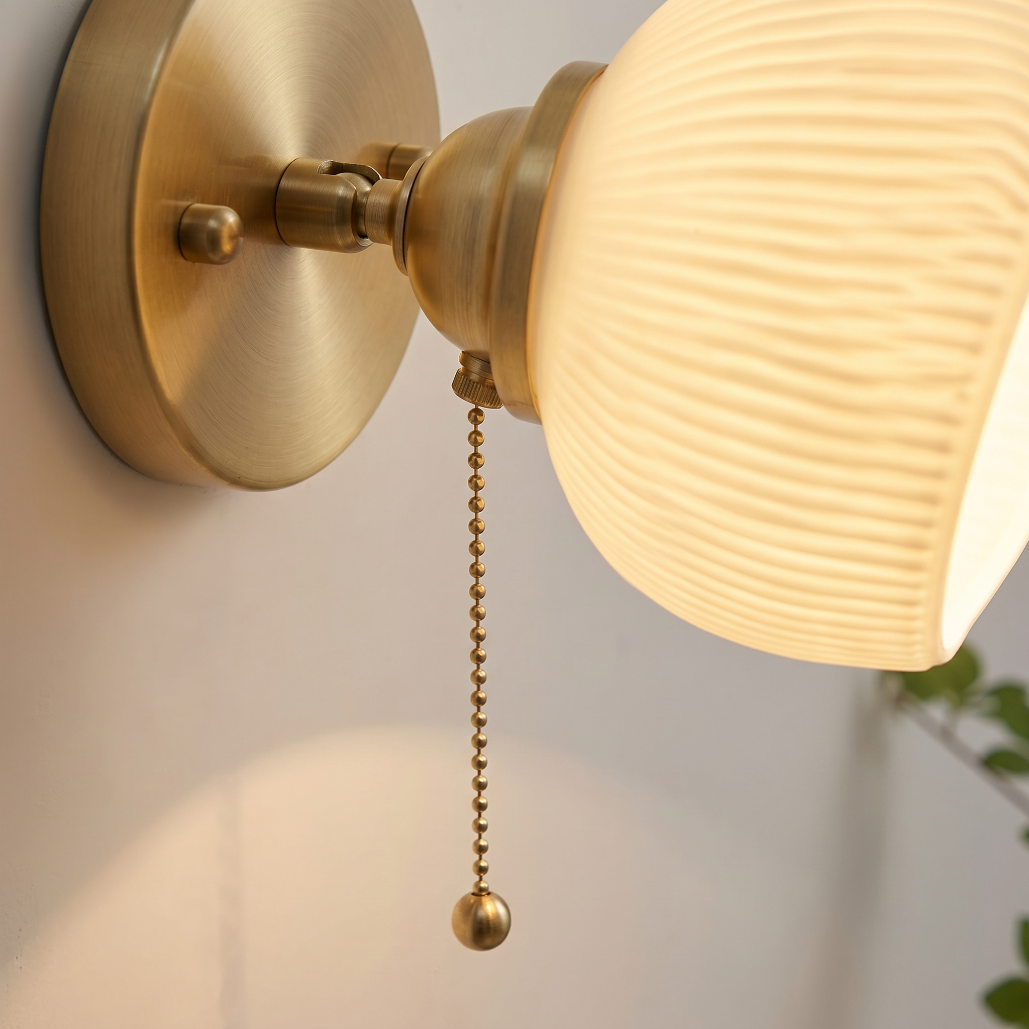 Close-up of the Giglio ribbed glass shade, brass arm and pull cord