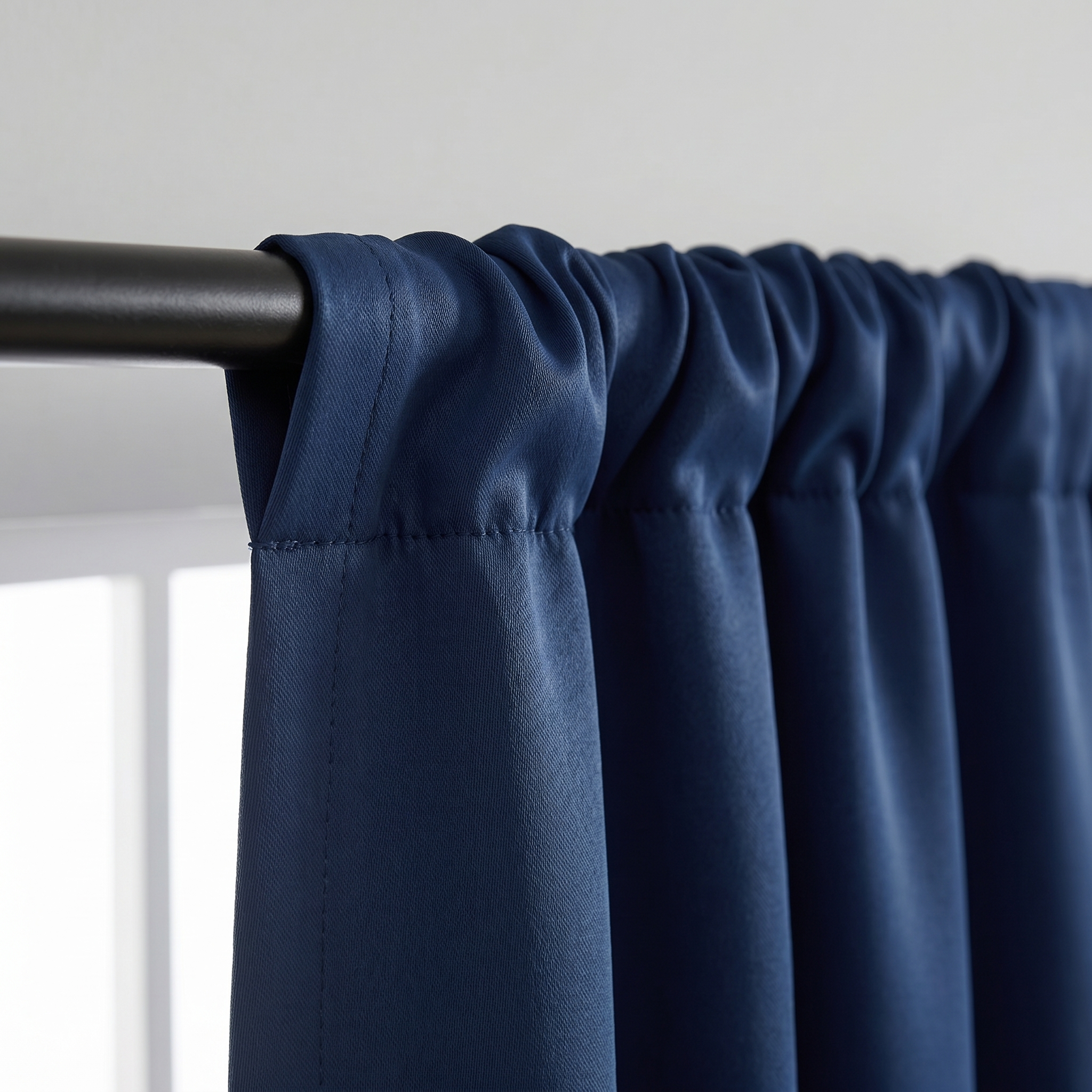 Triple-weave thermal blackout fabric and rod-pocket header detail