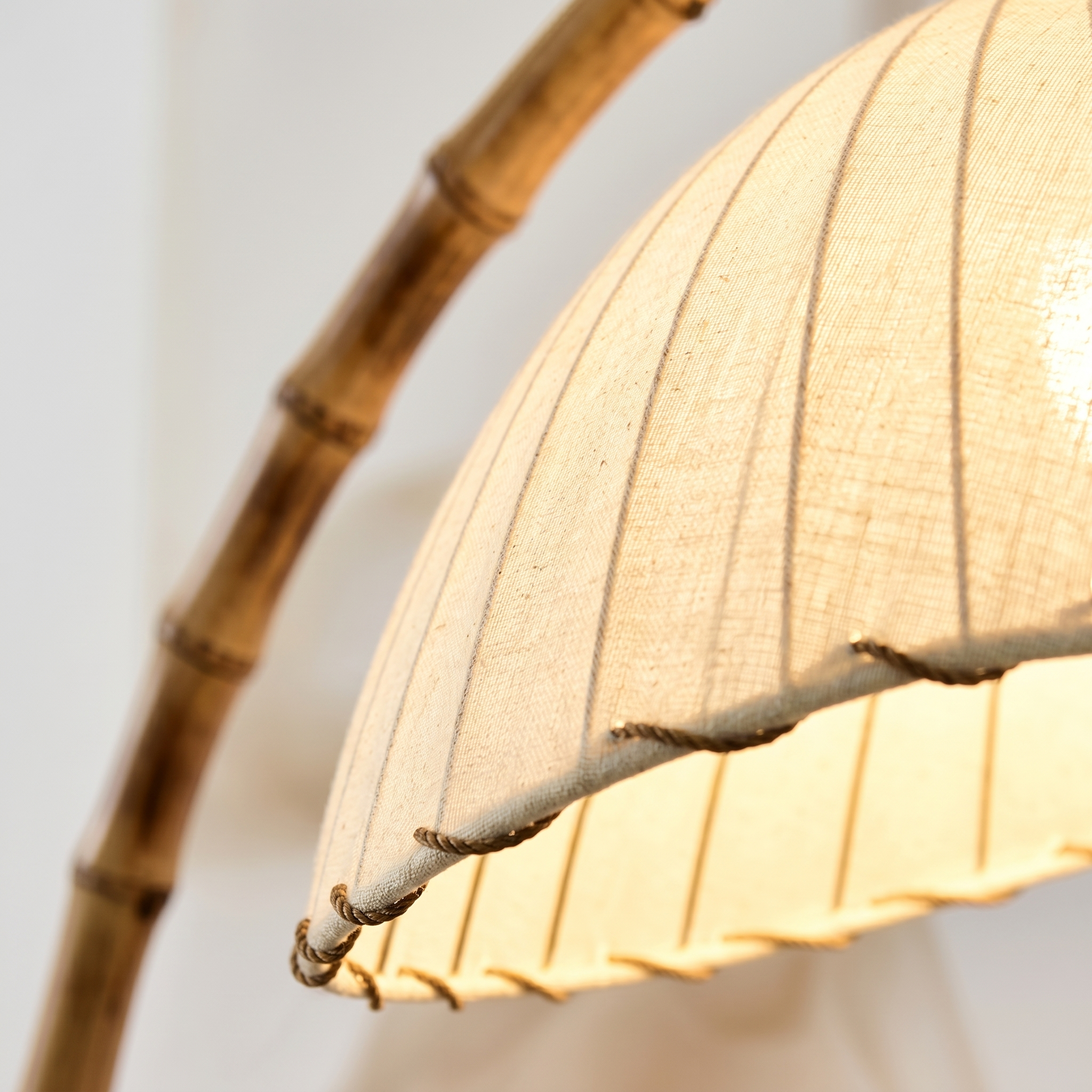 Detail of the pleated cream shade and simulated-bamboo pole