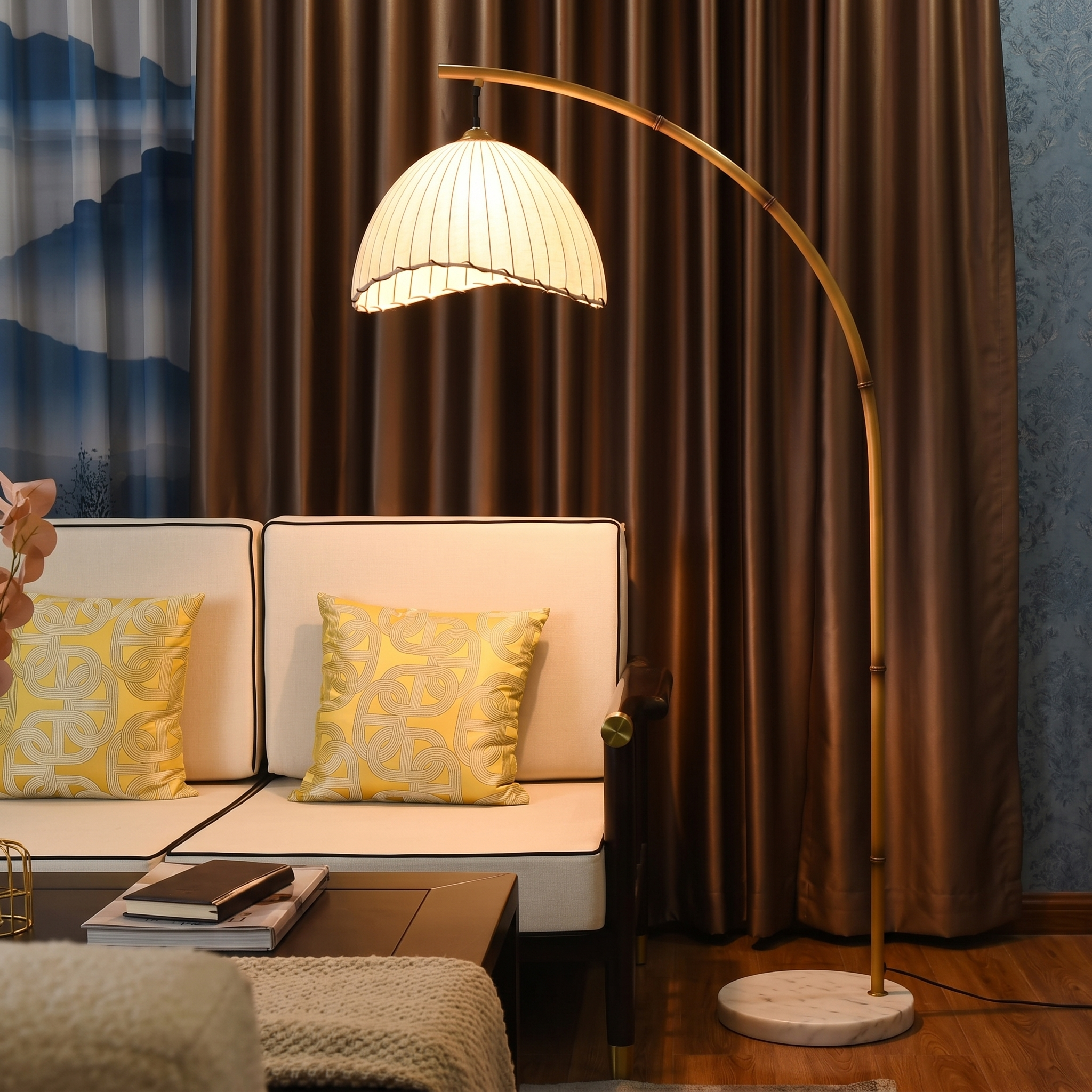 Bamboo arc floor lamp with a warm glow in a cozy living room