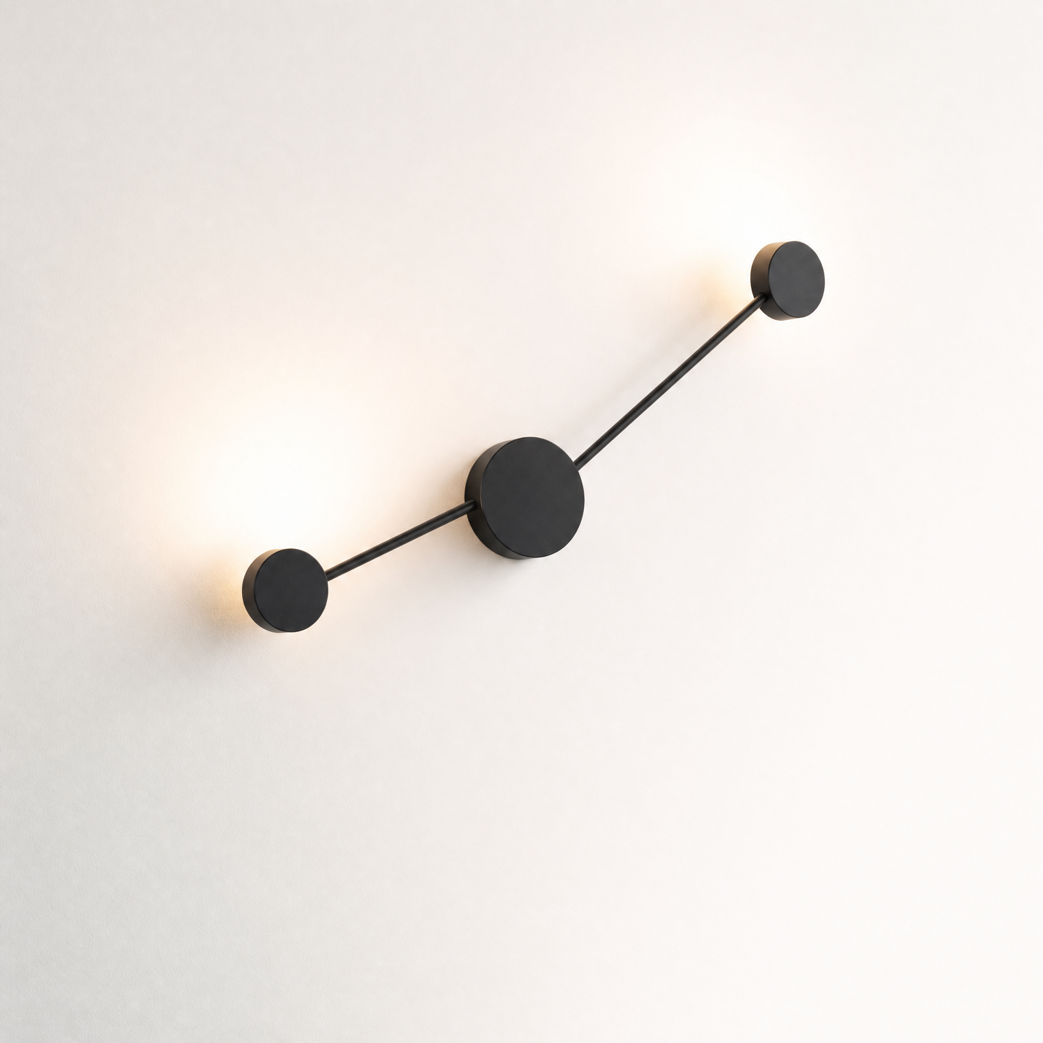 HERO Riflesso two-light wall lamp bouncing round glows on a white wall