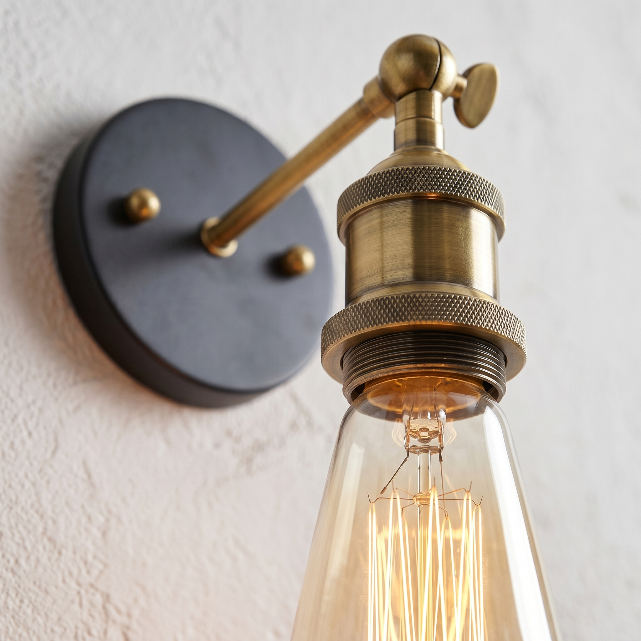 Close-up of the aged brass socket and glowing Edison bulb
