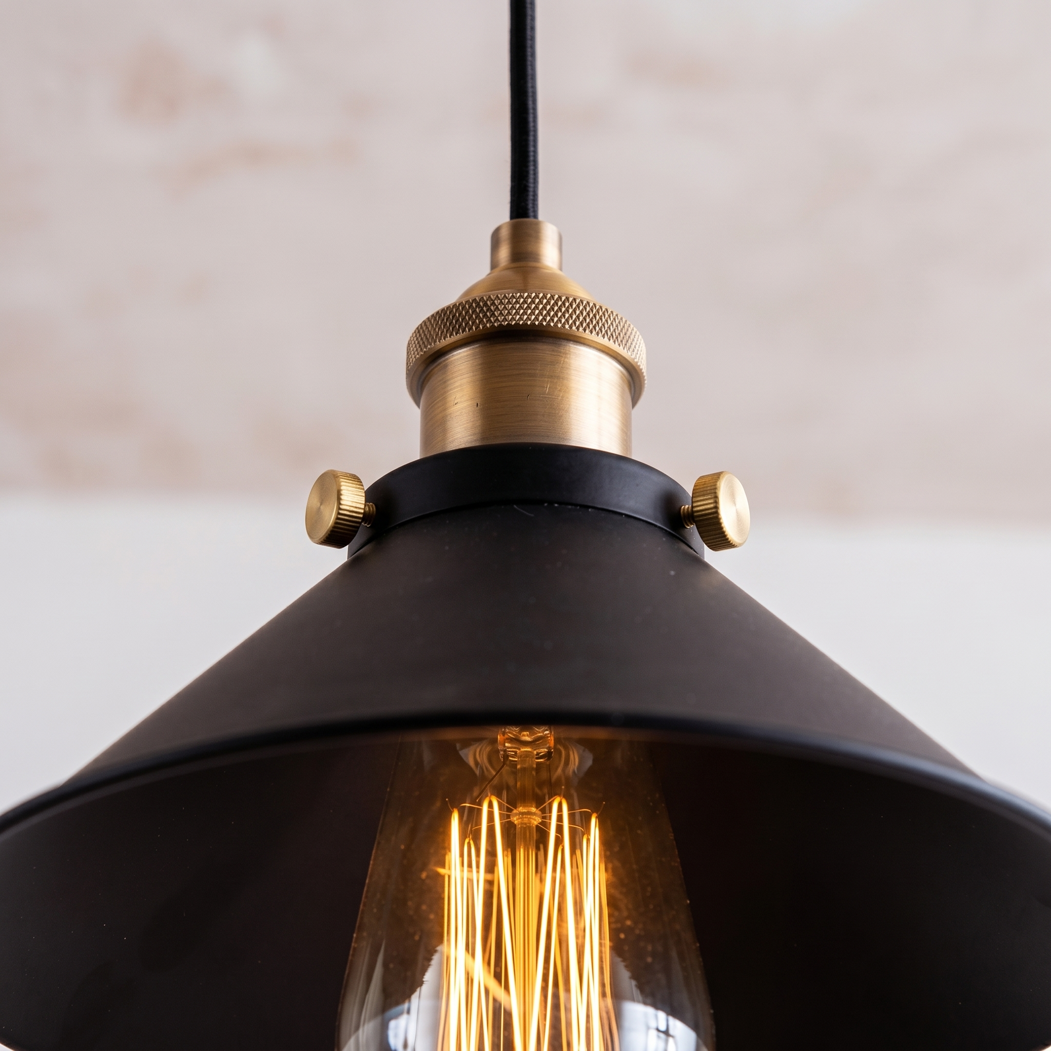 Close-up of the brass socket and Edison bulb of the Campana pendant