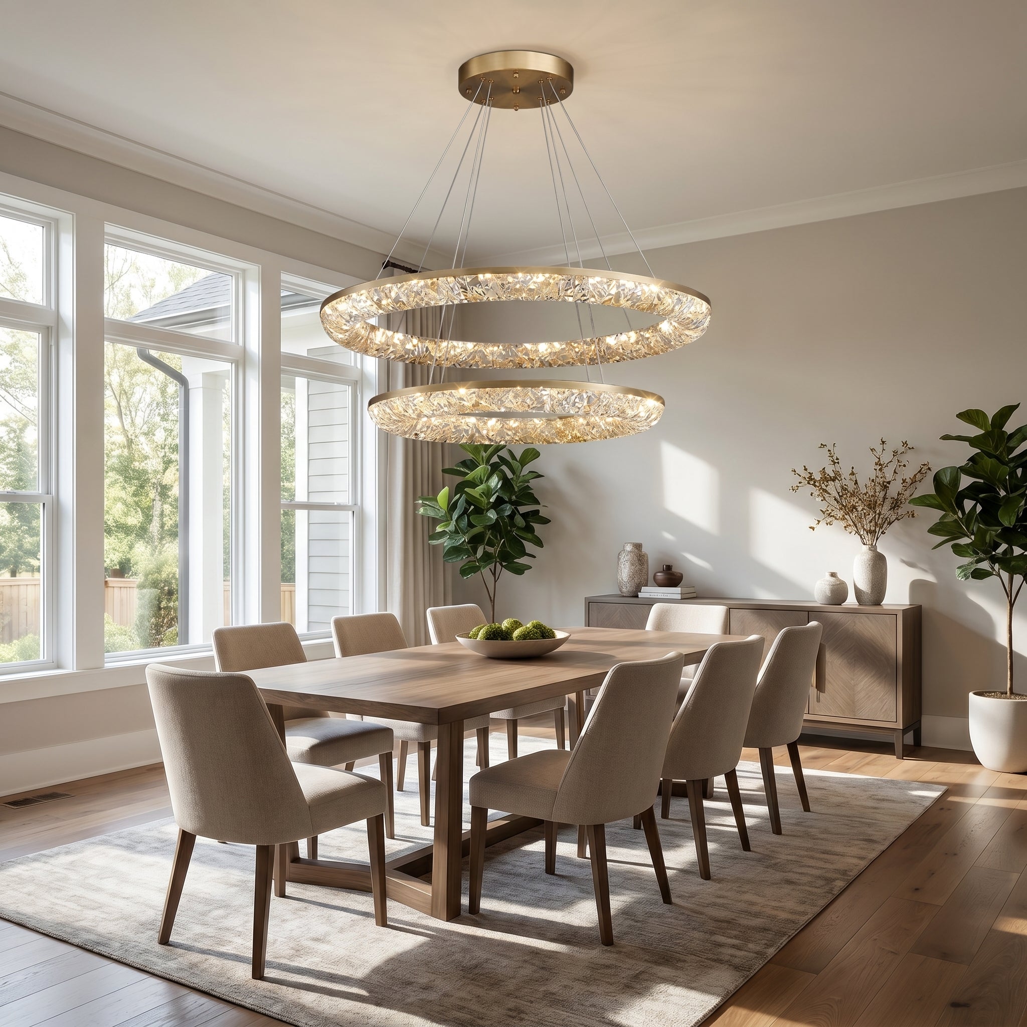 Stella Lucente gold crystal ring chandelier glowing over a dining table