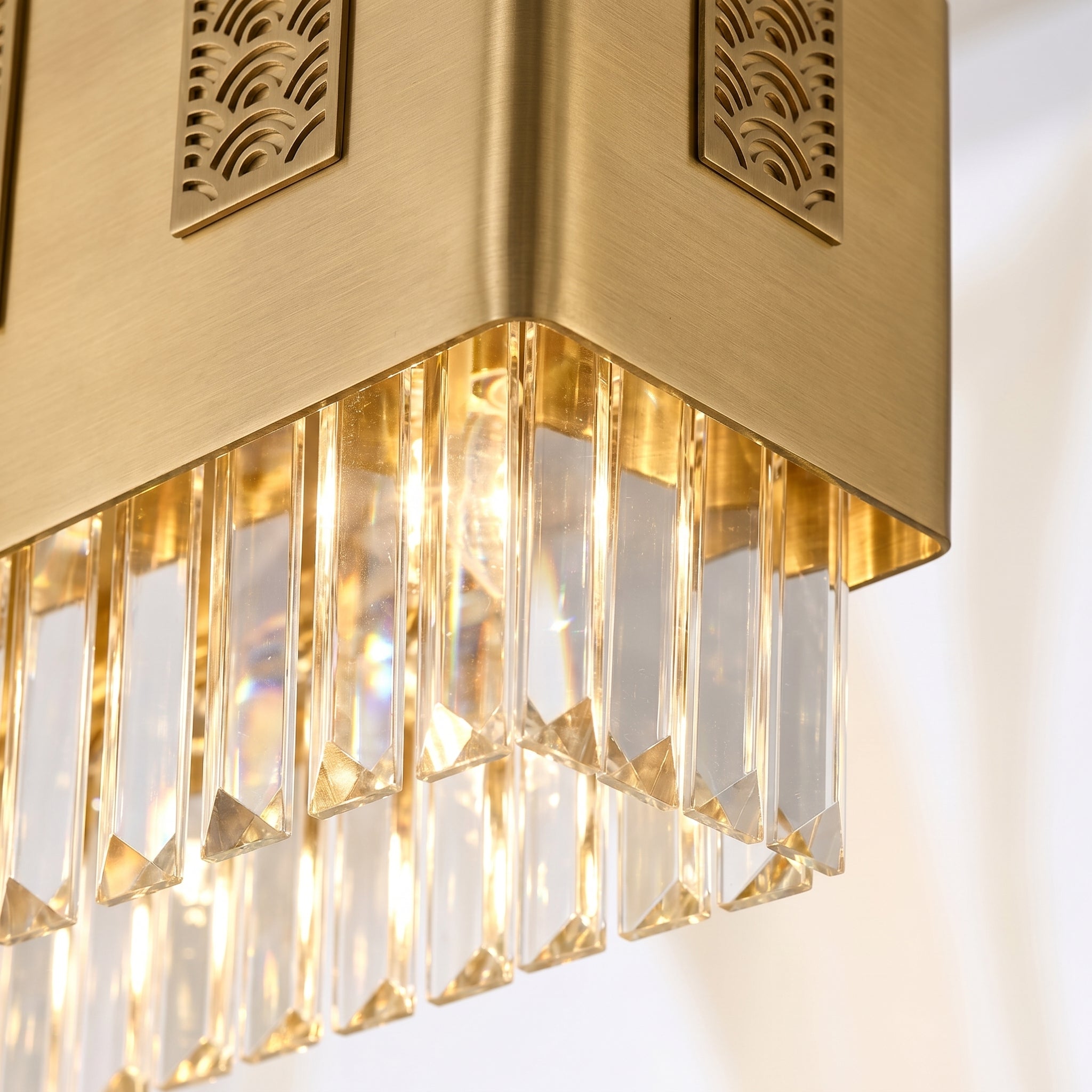 Macro detail of brushed brass frame and K9 crystal prisms