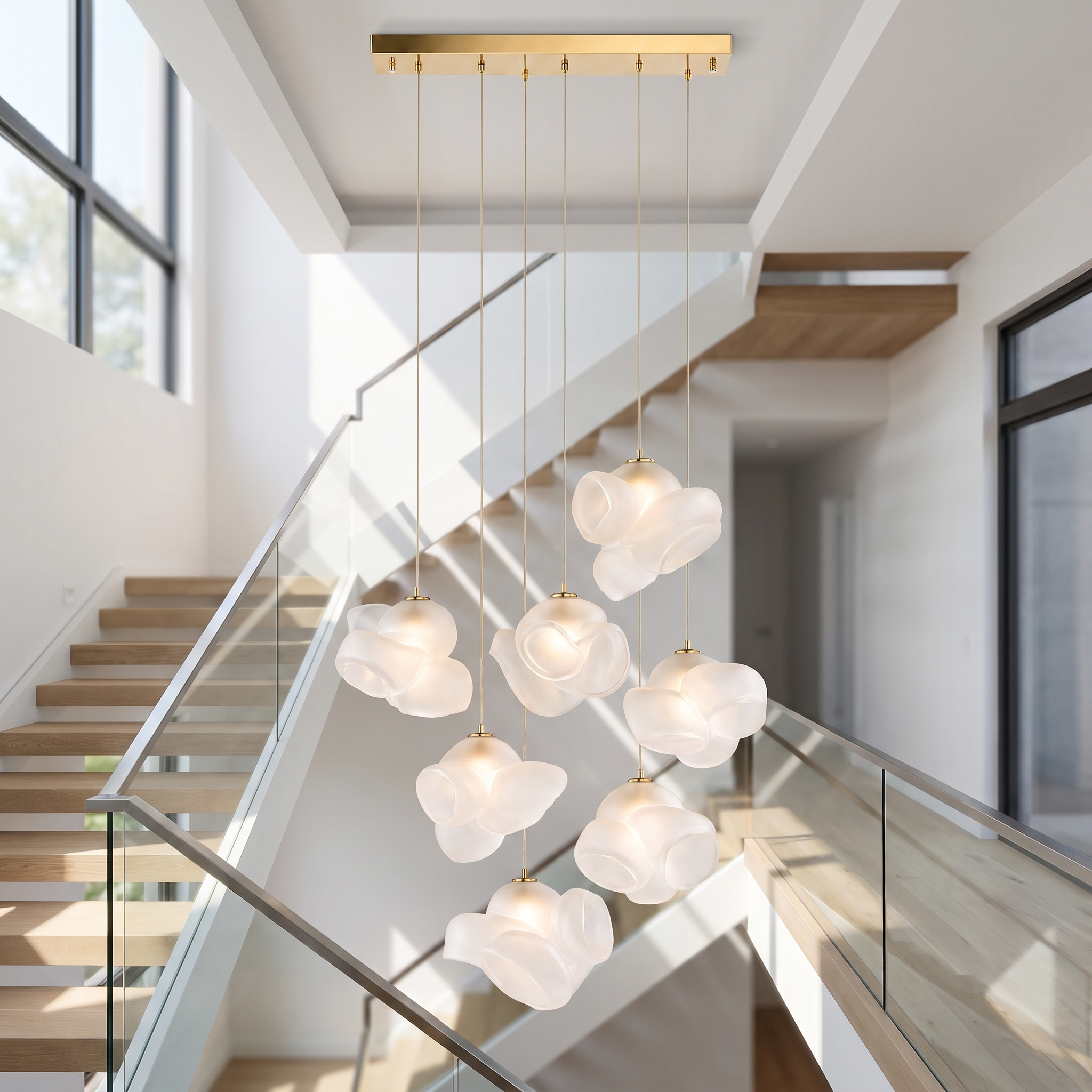 Frosted glass bloom chandelier mounted to the ceiling at the top of a bright staircase