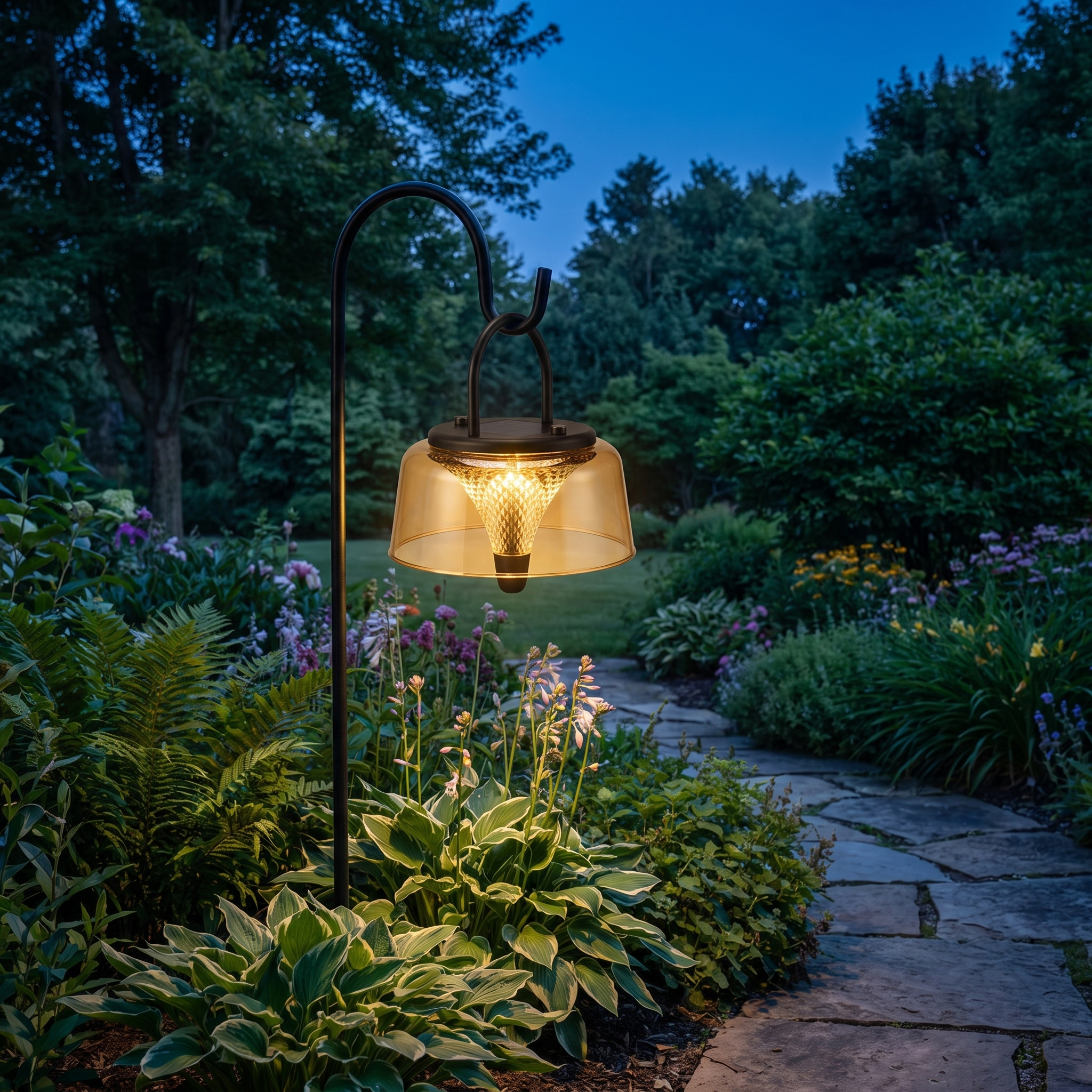 Portable solar lantern hanging from a shepherd's hook in a garden at twilight blue hour