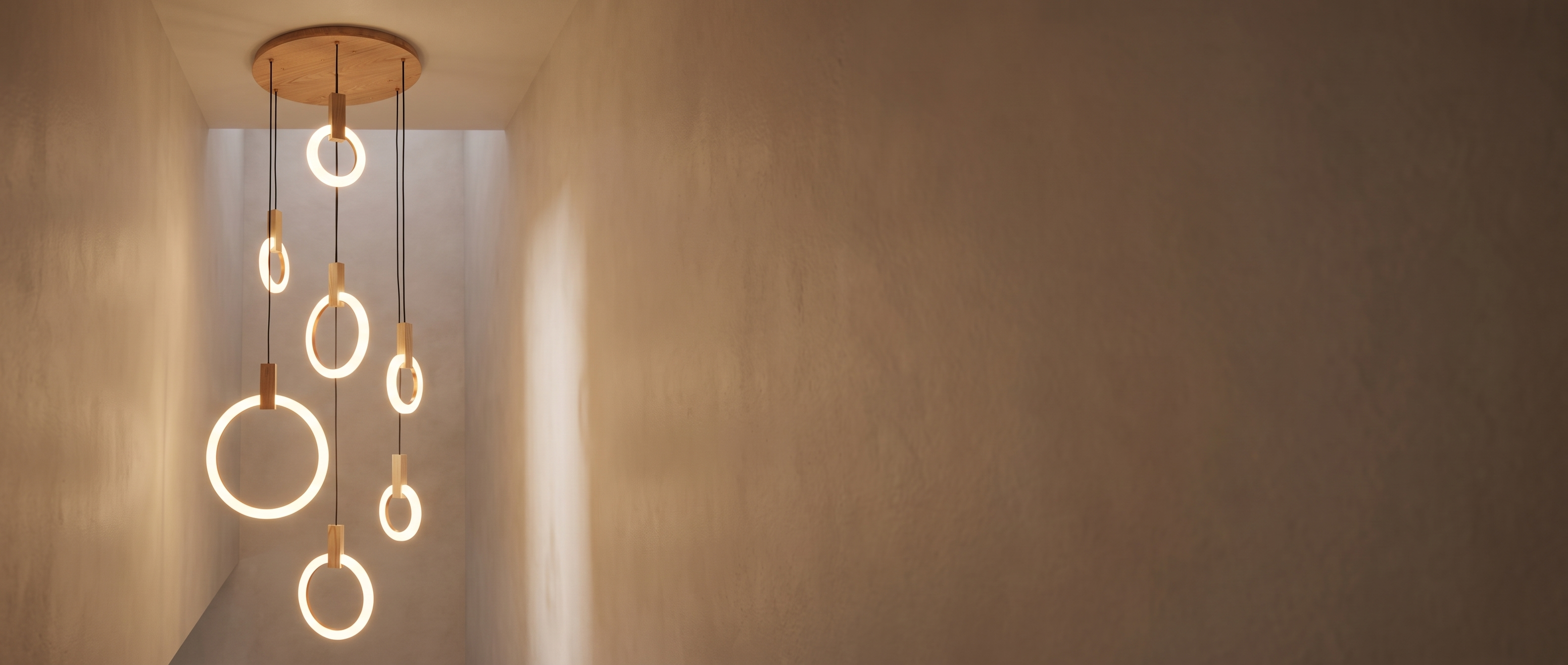 Wood ring chandelier cascading in a stairwell