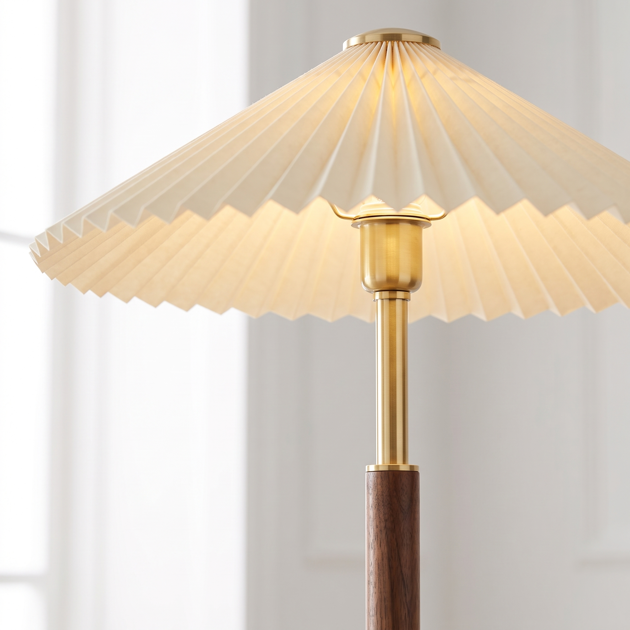 Close up of the cream pleated shade and brass walnut joint detail