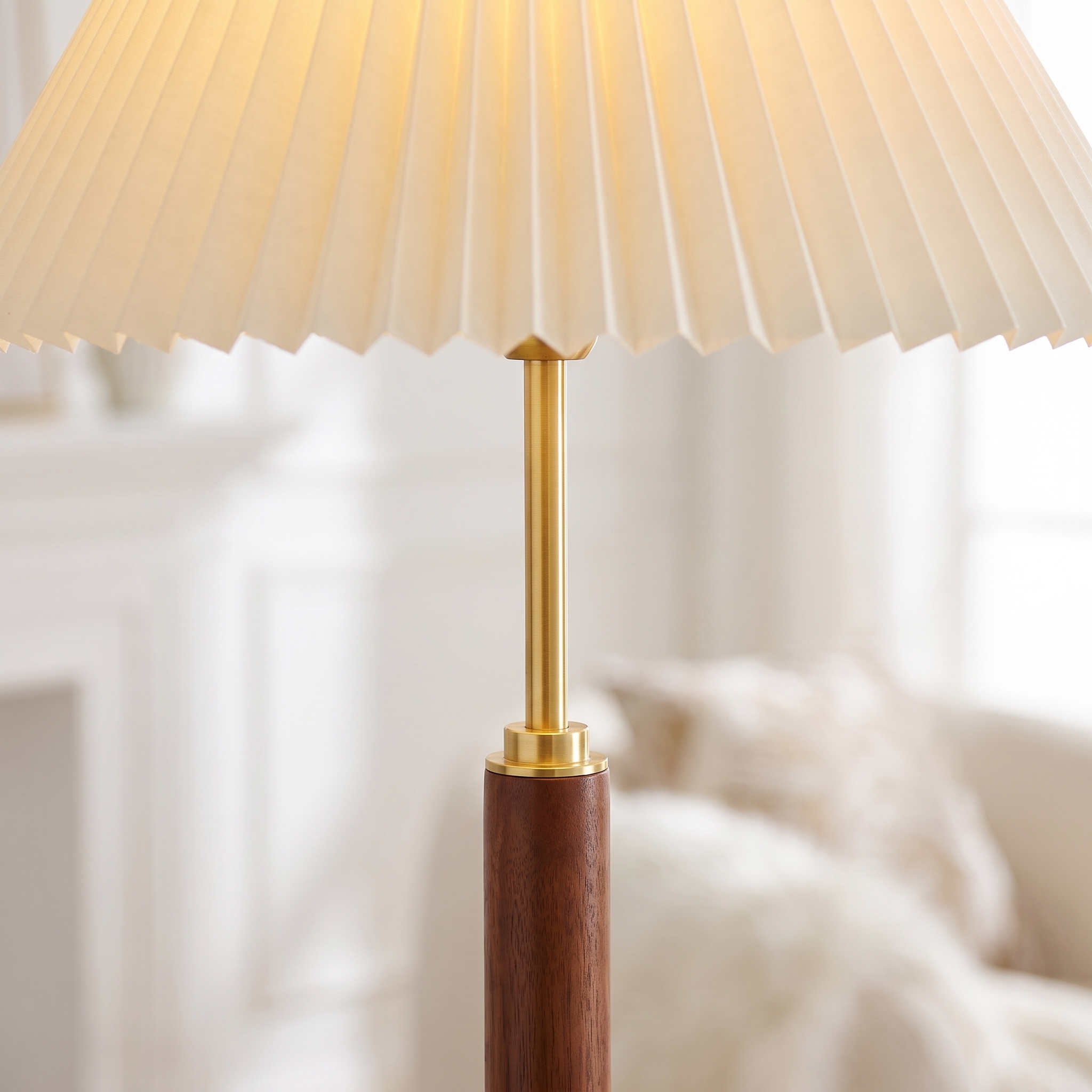 Close-up of the pleated shade, brass stem and walnut pole