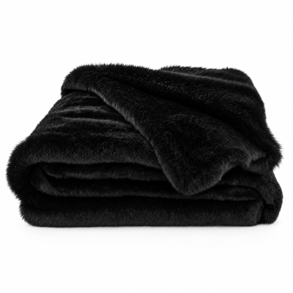 Carezza Sontuosa faux fur throw blanket in black, folded on white